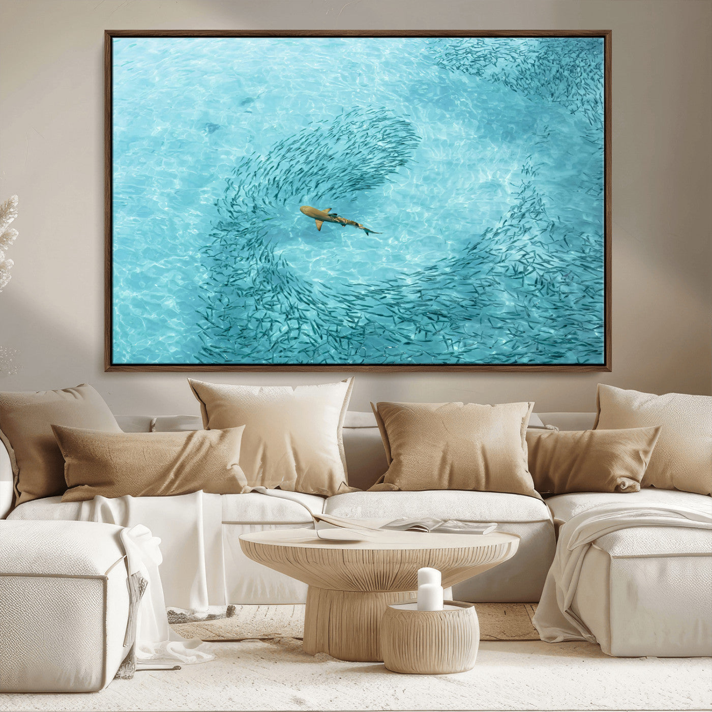 Aerial view of a shark swimming through a swirl of fish in clear turquoise waters, perfect for calm coastal or beach house decor.