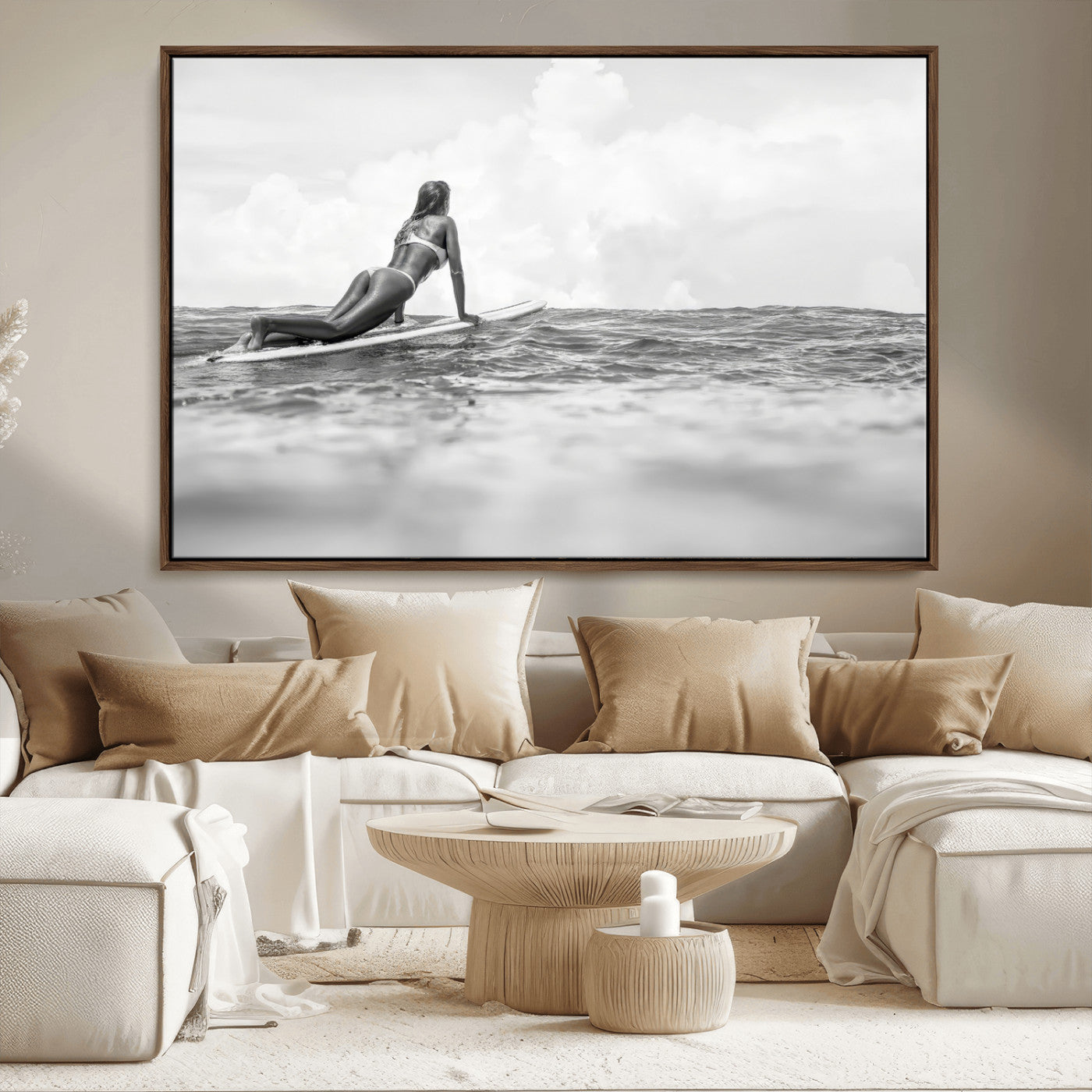 A black and white ocean scene featuring a surfer girl waiting on her board, gazing at the horizon, capturing a tranquil and adventurous coastal moment.