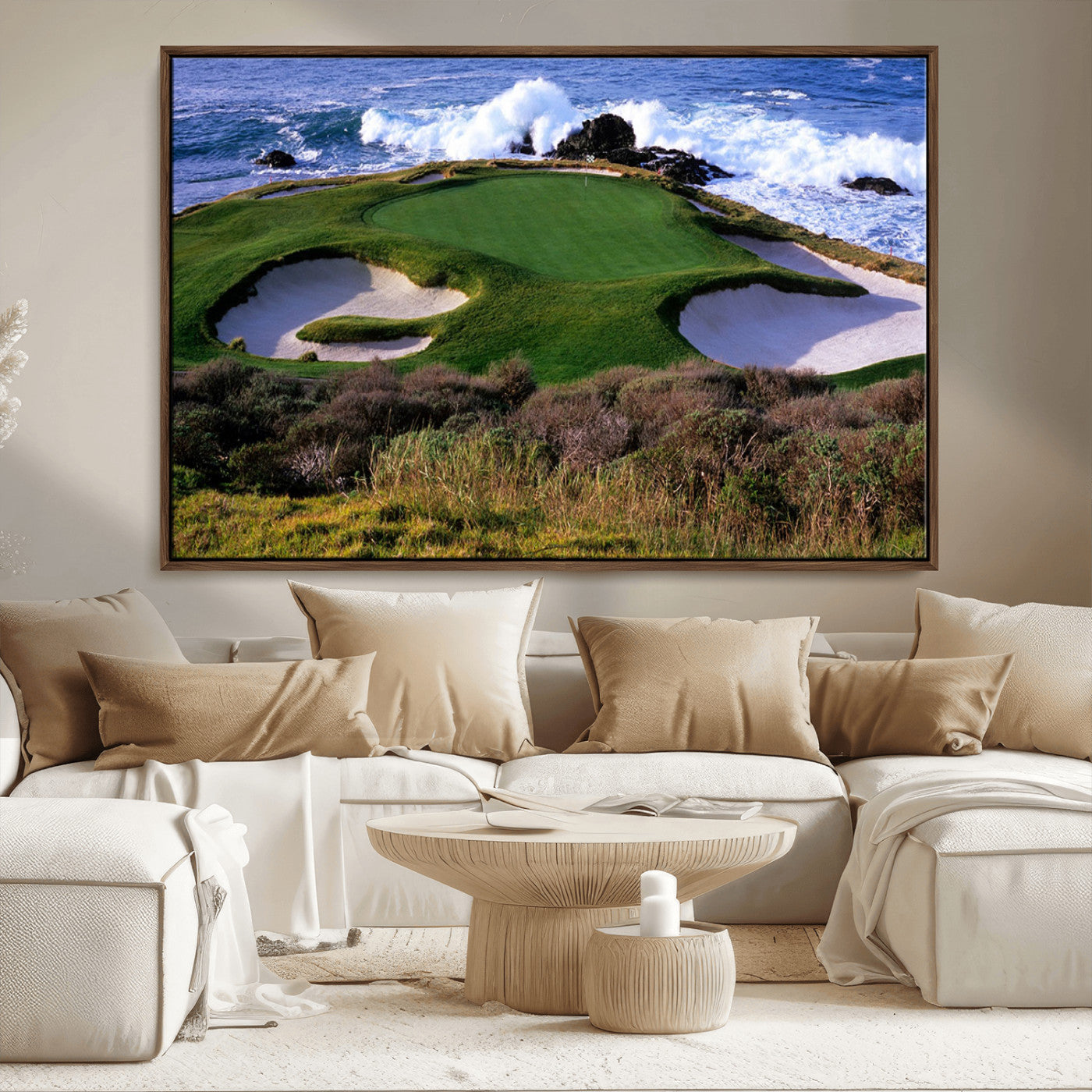 A scenic golf course located by the ocean, featuring a well-manicured green surrounded by sand traps and powerful ocean waves crashing on the shore.