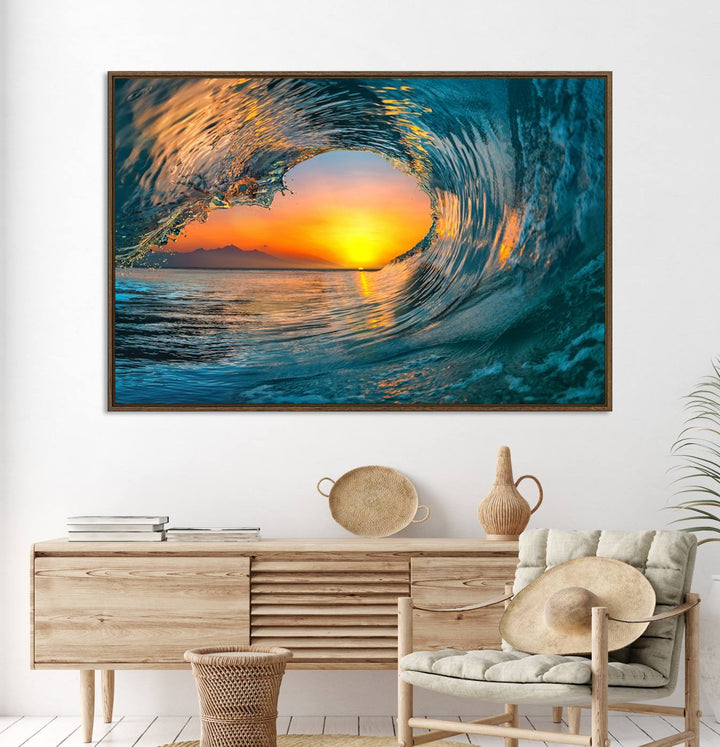 The Ocean Wave Sunset Wall Art canvas print features a vibrant ocean wave at sunset, forming a tunnel with silhouetted mountains.