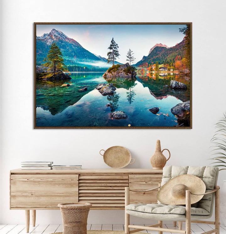 The 3-panel wall art showcases a serene mountain lake with rocky islands and trees, creating an ideal focal point for dining rooms or offices.