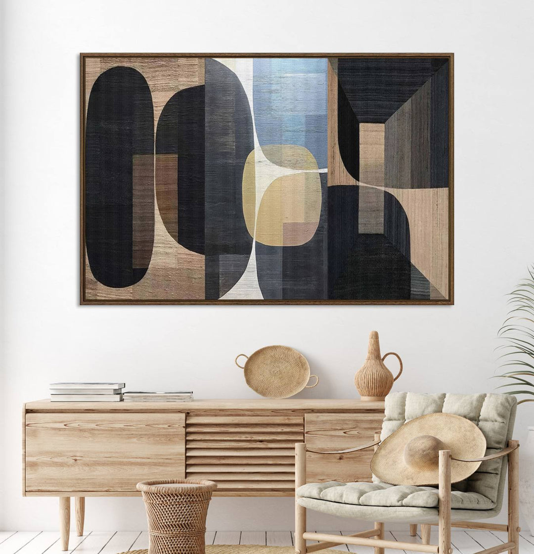 Abstract geometric wall art featuring black, gray, beige, and blue tones framed in a wooden border.