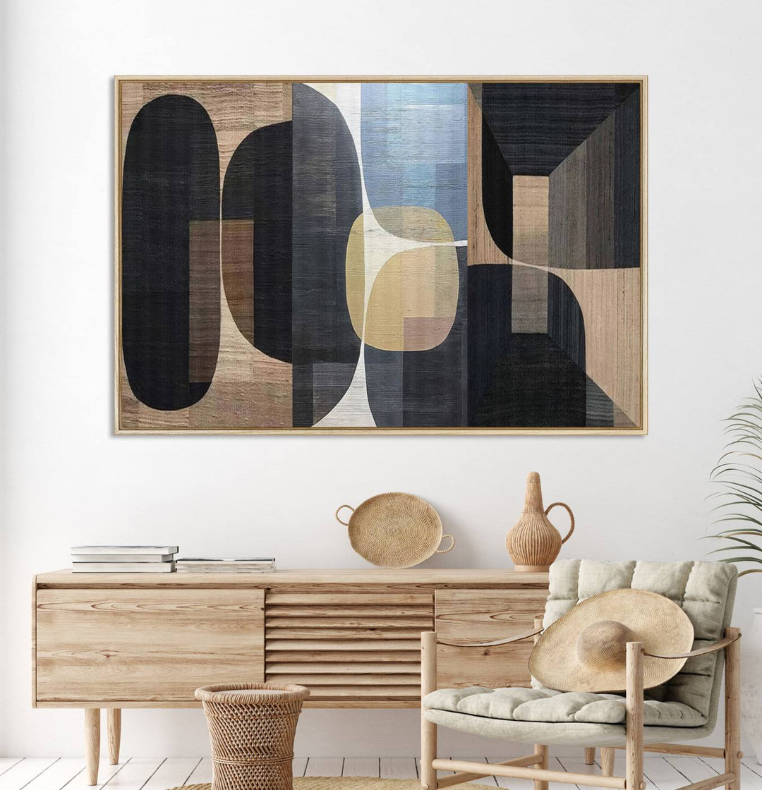 Abstract geometric wall art featuring black, gray, beige, and blue tones framed in a wooden border.