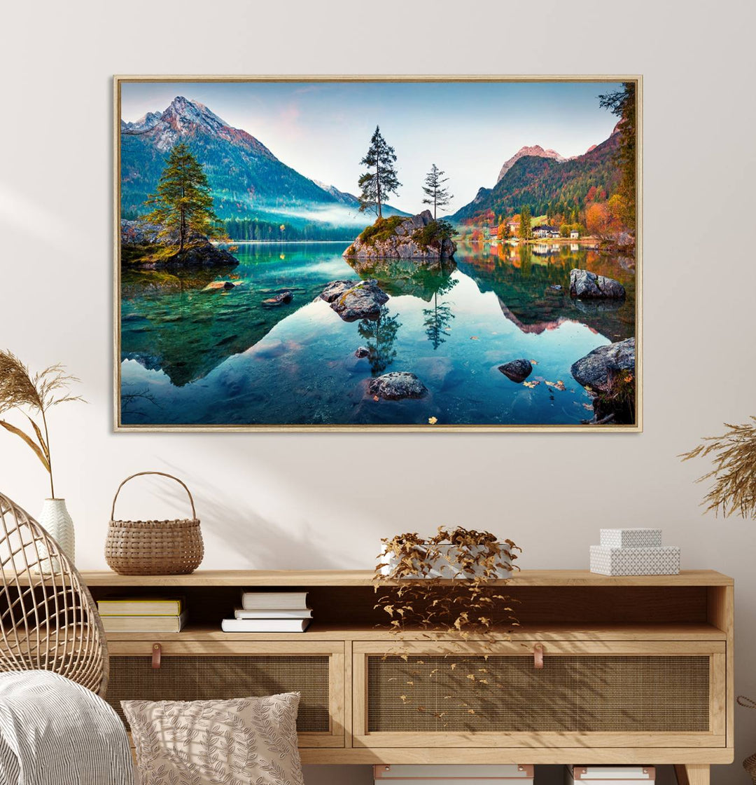 The 3-panel wall art showcases a serene mountain lake with rocky islands and trees, creating an ideal focal point for dining rooms or offices.