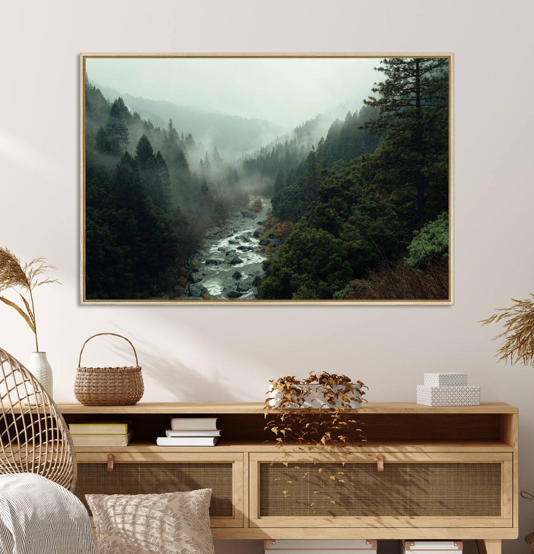 The Misty Forest Wall Art features a serene landscape with a misty river and evergreens, ideal for enhancing the ambiance of any living room or cabin.