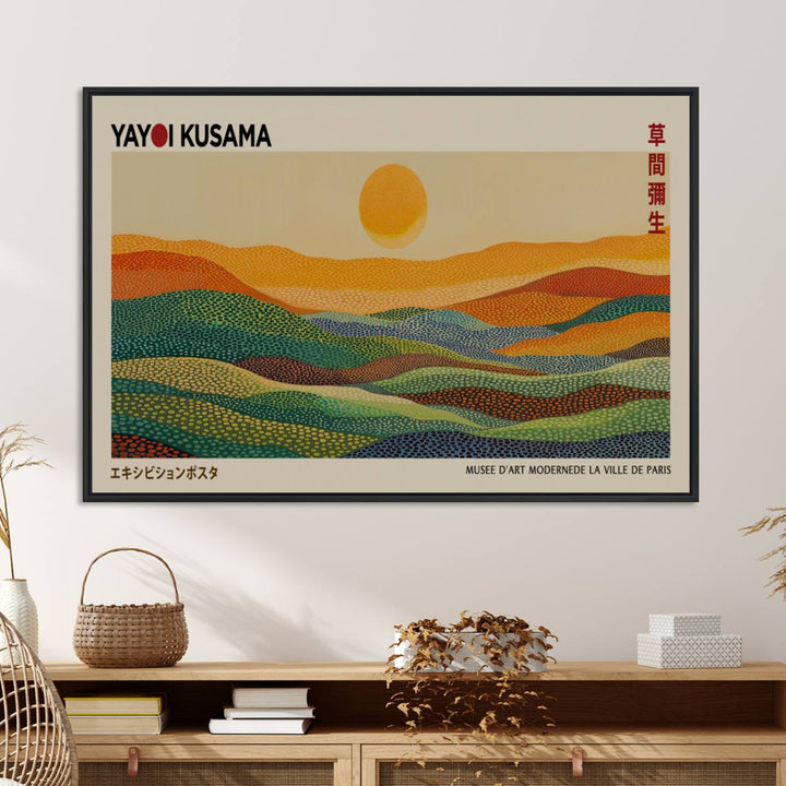 A framed Yayoi Kusama 1986 wall art print showcases a vibrant abstract landscape with colorful, wavy dots and a sun above the horizon.