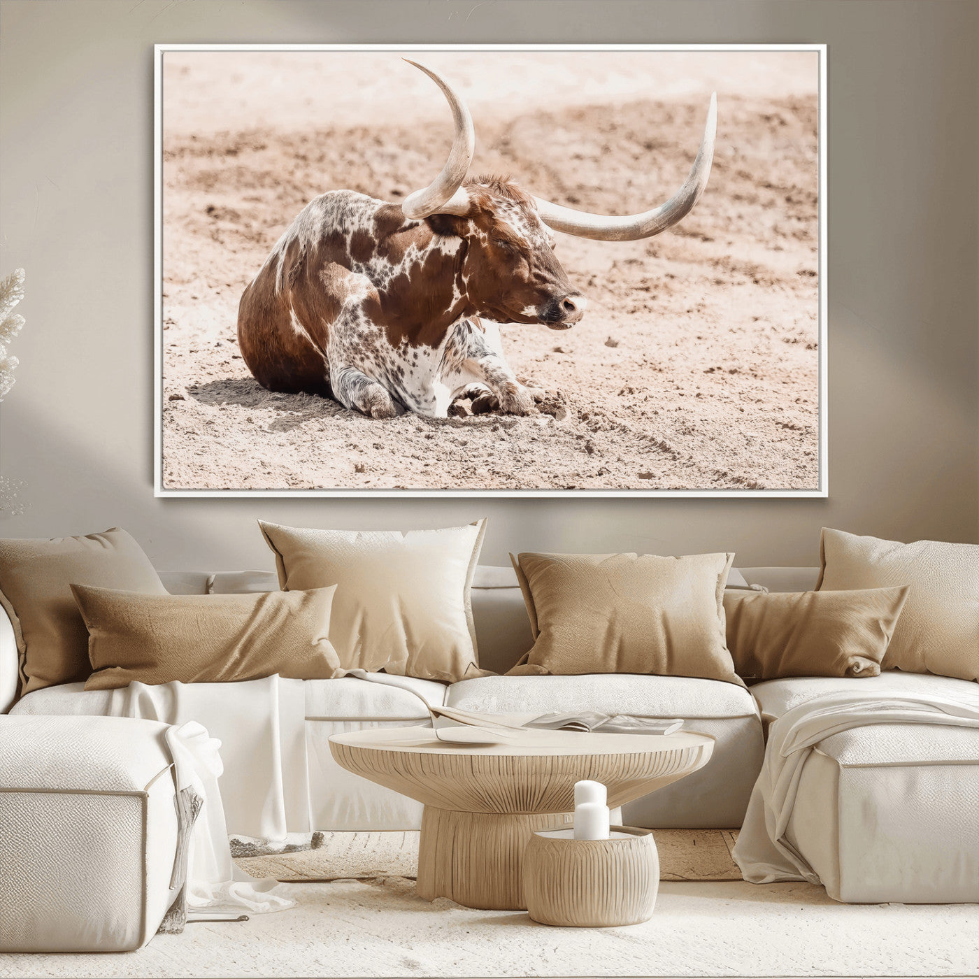 Texas Longhorn bull resting on dusty ground with warm tones, ideal for rustic western or farmhouse-themed wall decor.