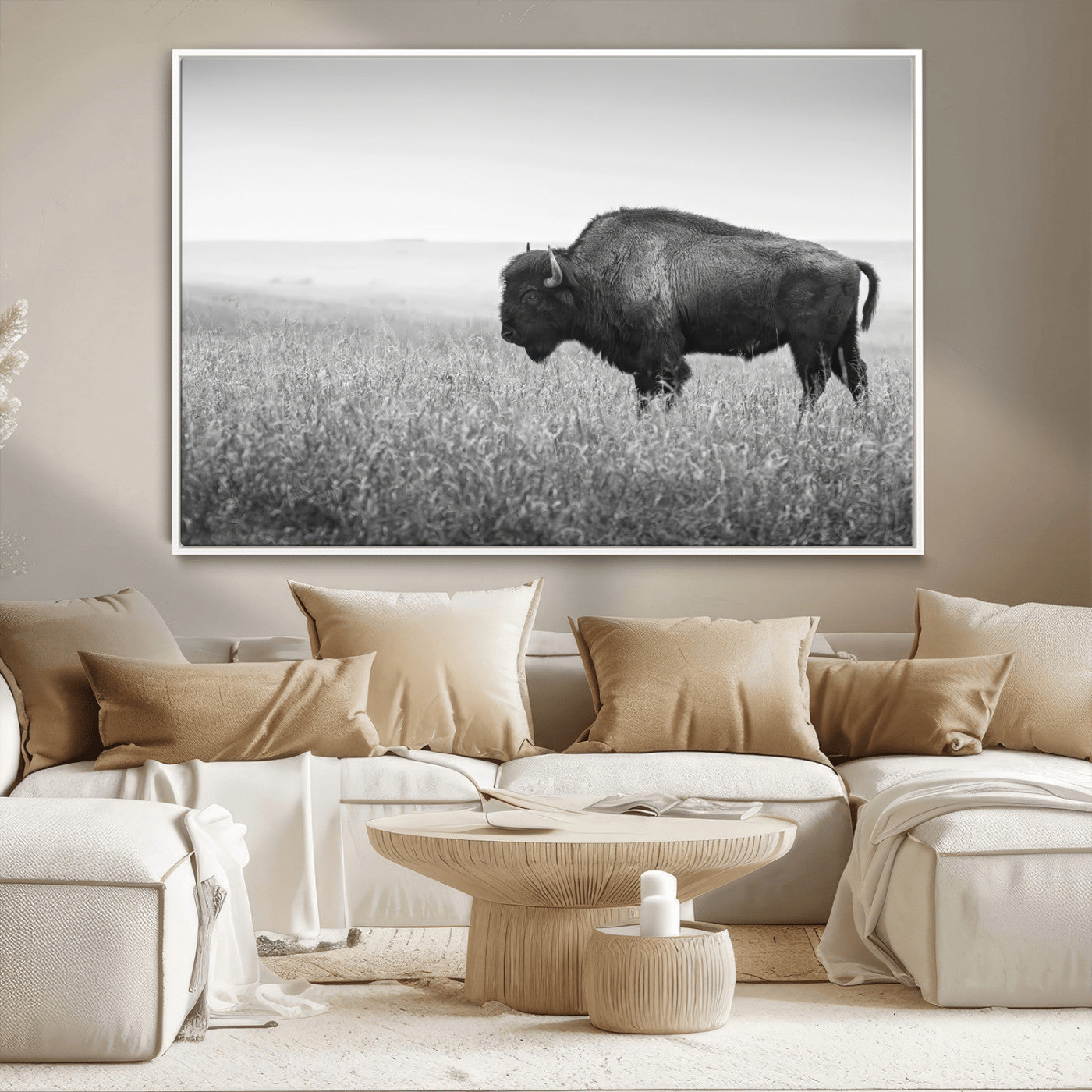 A black and white photograph of a majestic bison standing in a vast grassy prairie, evoking a sense of wilderness and strength.