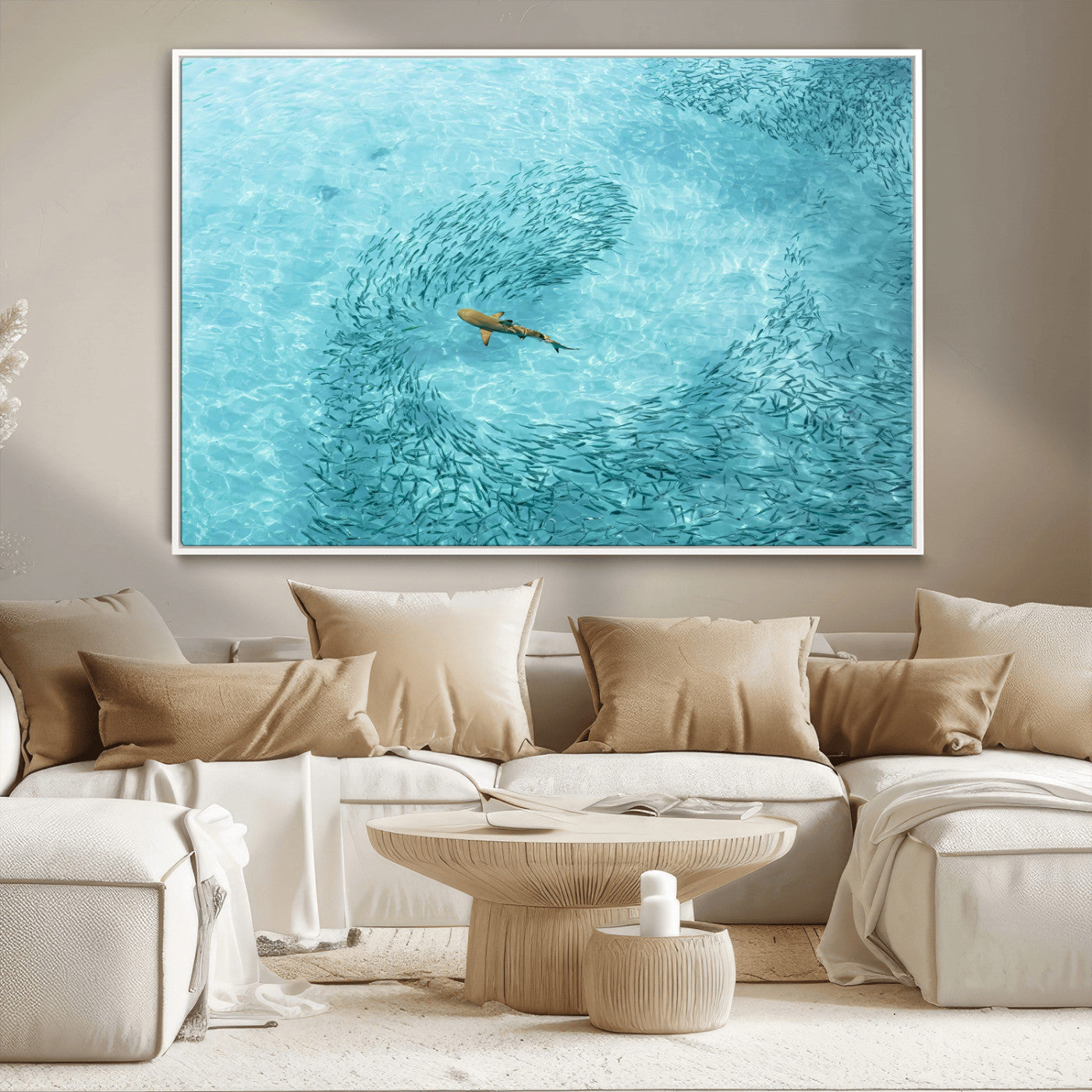 Aerial view of a shark swimming through a swirl of fish in clear turquoise waters, perfect for calm coastal or beach house decor.