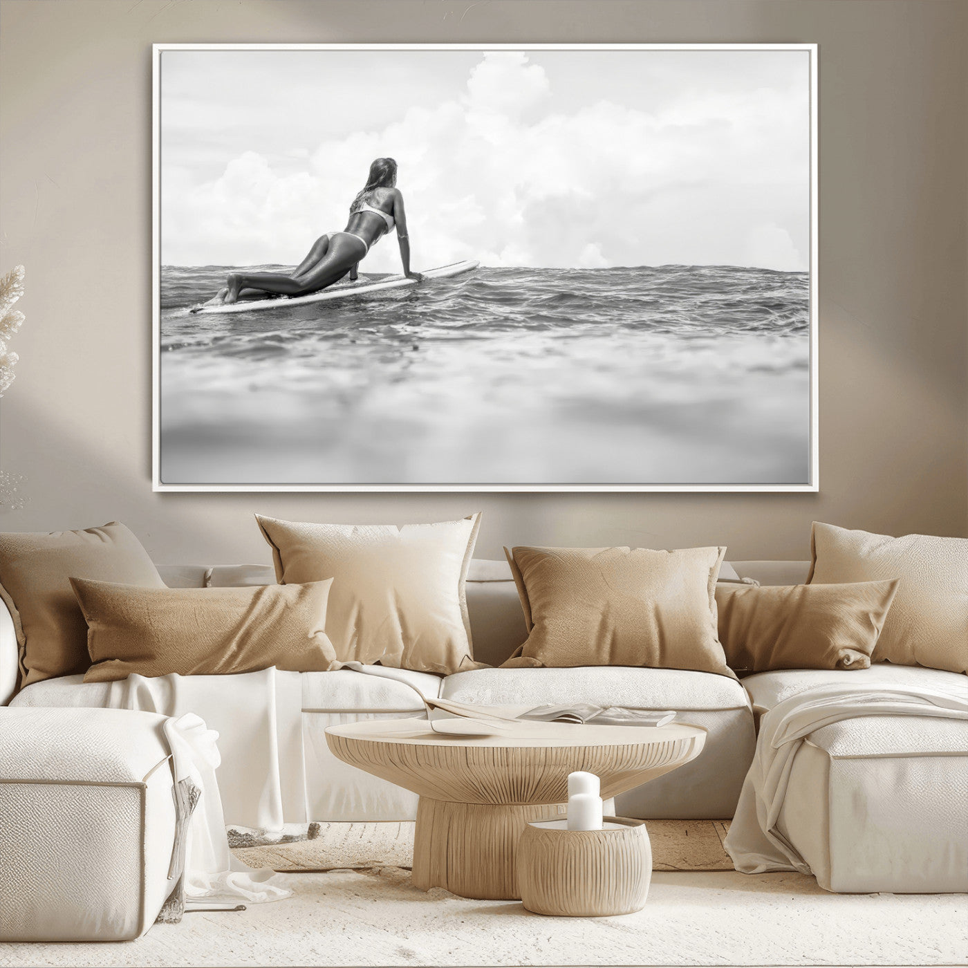 A black and white ocean scene featuring a surfer girl waiting on her board, gazing at the horizon, capturing a tranquil and adventurous coastal moment.