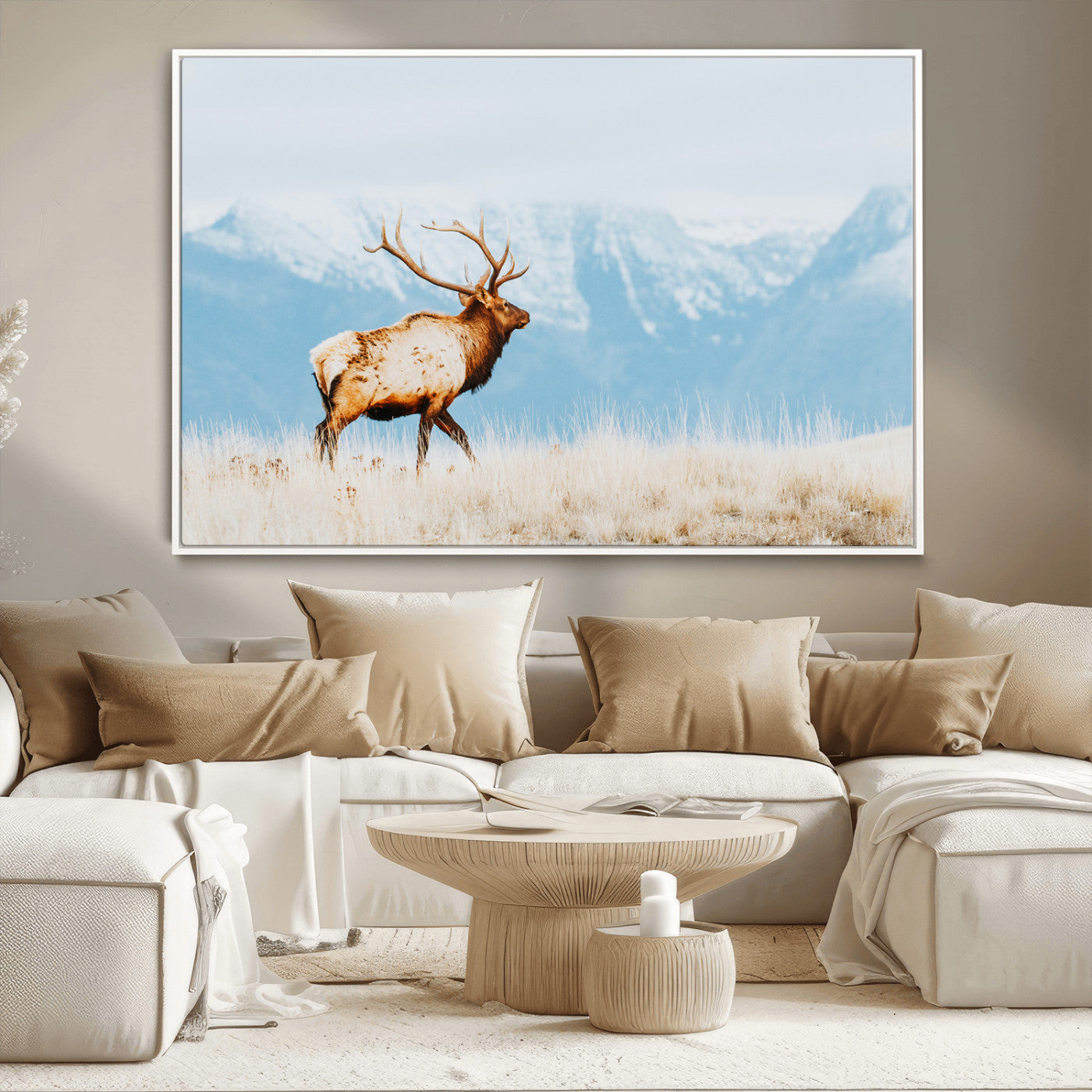 Majestic elk standing on dry grassland with snowy mountains in the background, ideal for rustic or lodge-inspired wall decor.