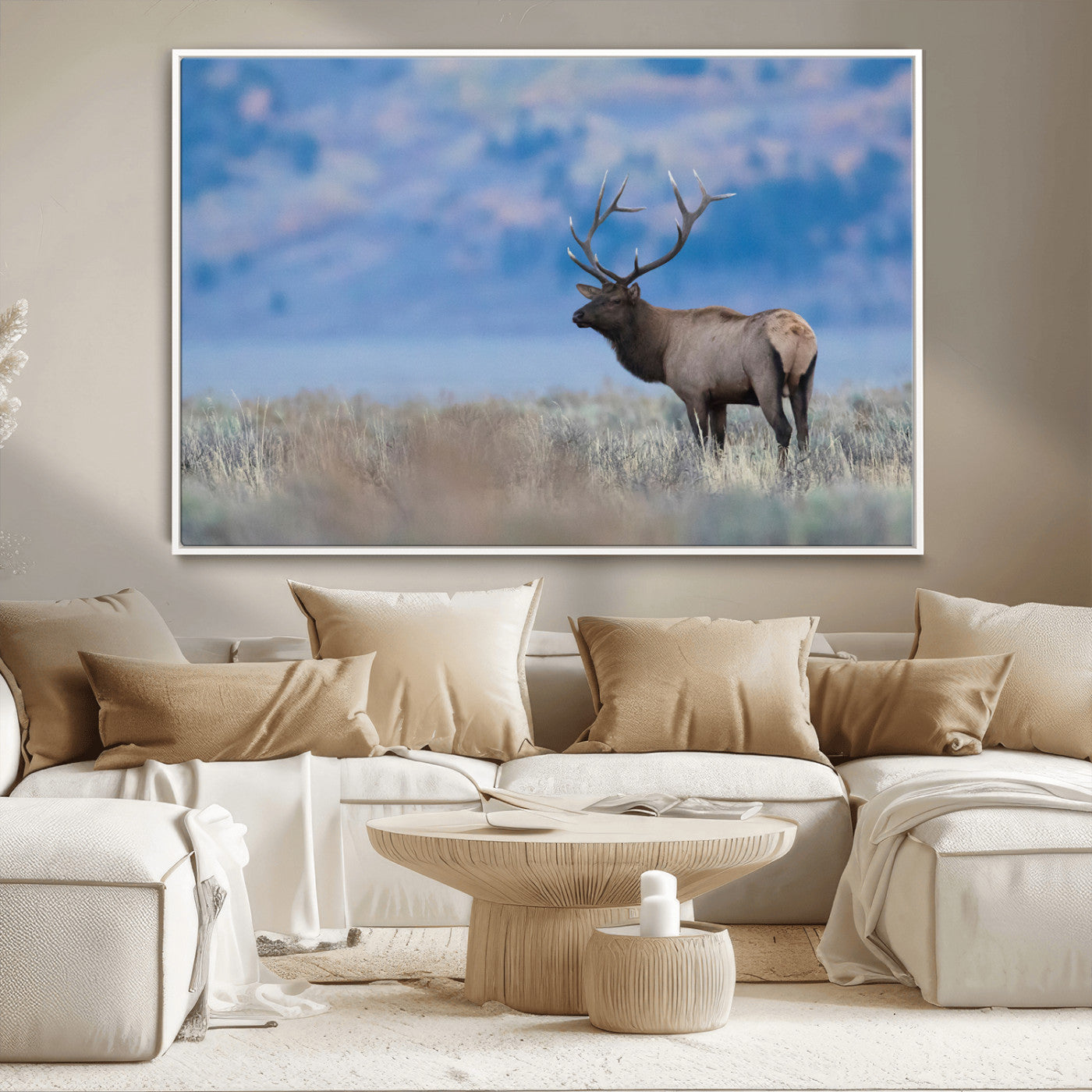 Elk with large antlers standing in open field, mountains blurred in background, perfect for rustic cabin or lodge-style decor.