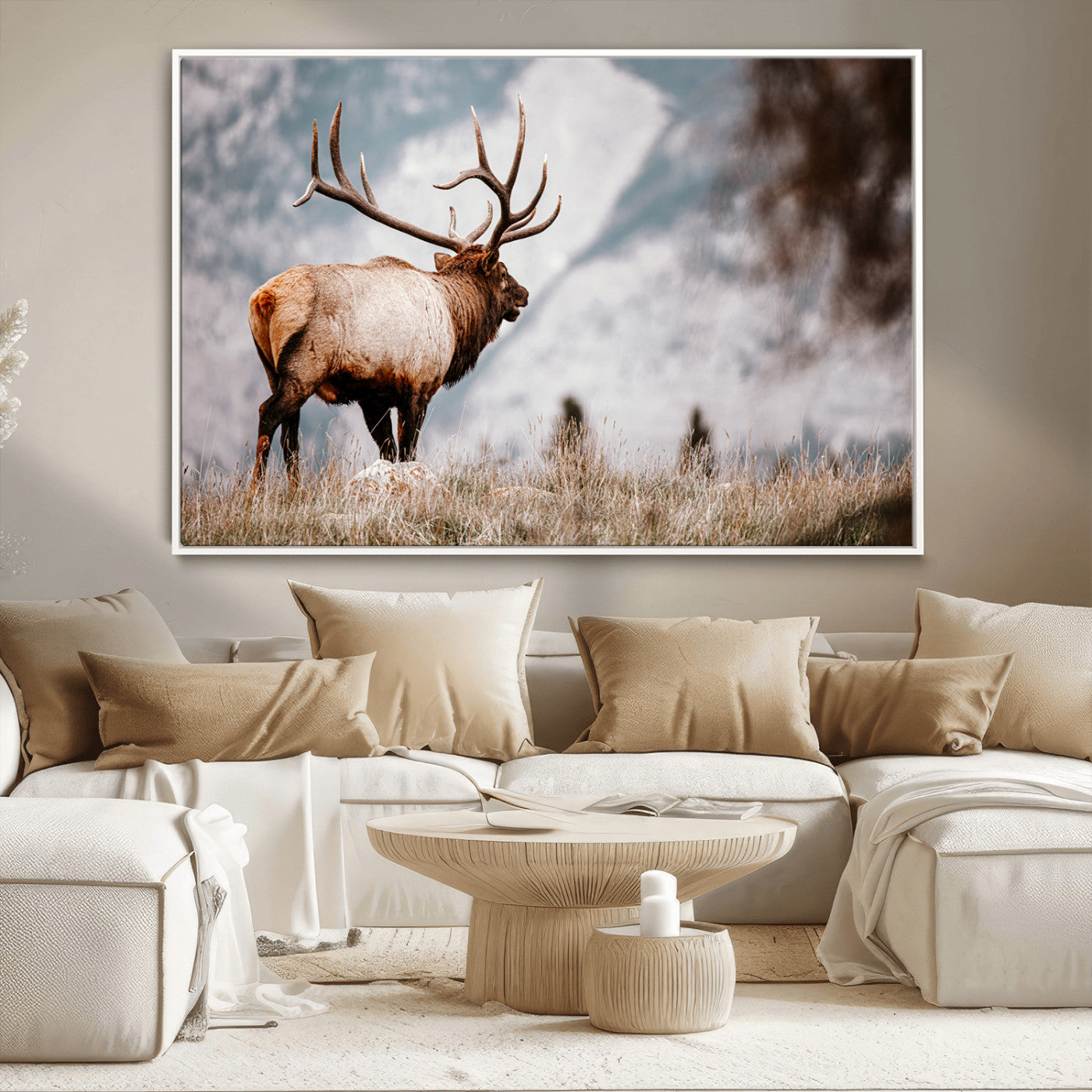 Majestic elk with large antlers standing in grass with snowy mountains in background, perfect for rustic cabin or lodge style decor.