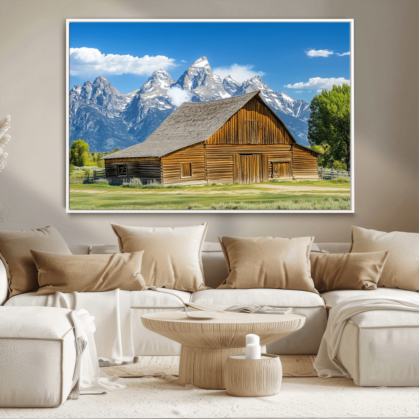 A rustic wooden barn sits in front of towering mountain peaks under a clear blue sky, perfect for farmhouse or cabin style interiors.