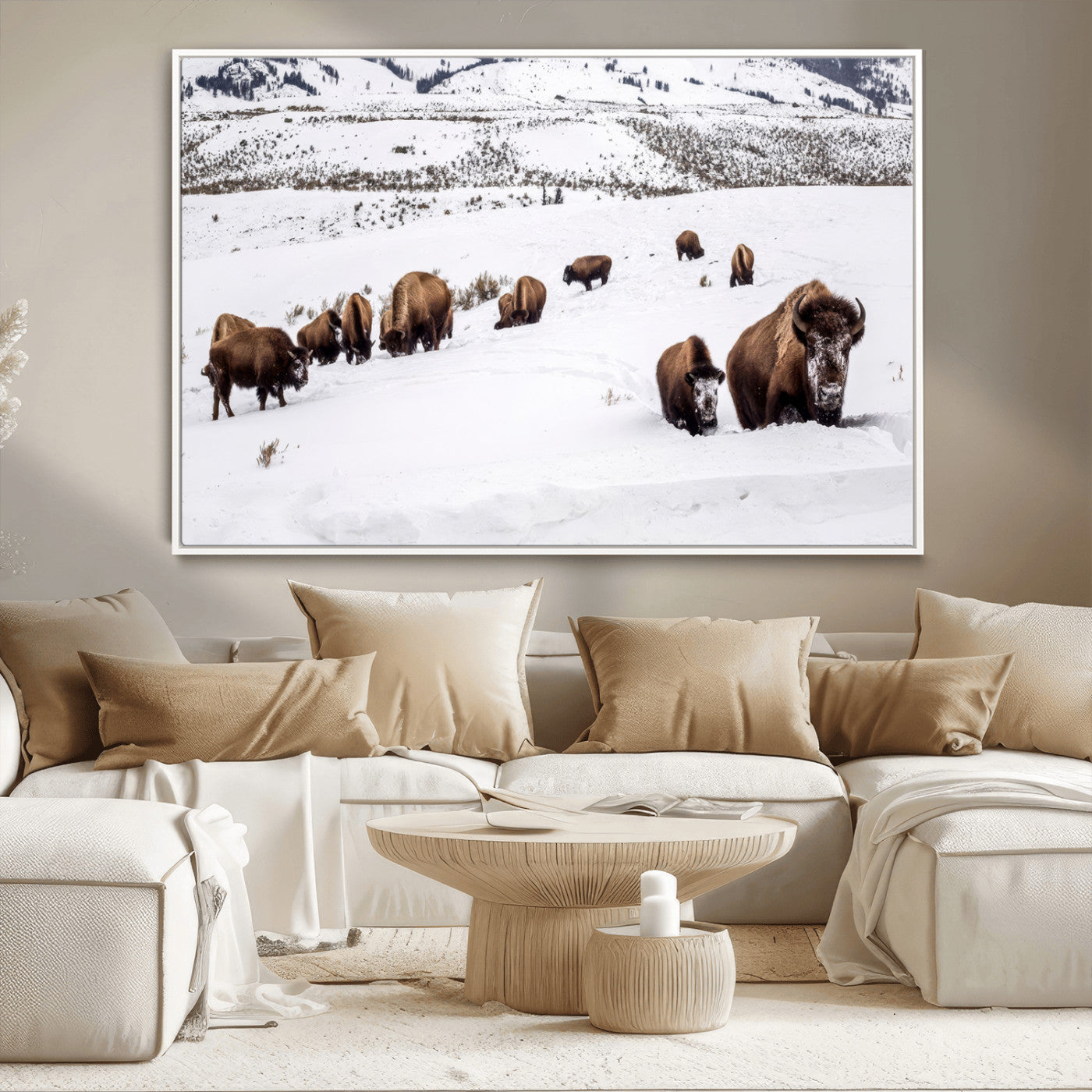 A herd of bison walking through deep snow in a mountain valley, perfect for rustic, cabin or western-themed wall decor.