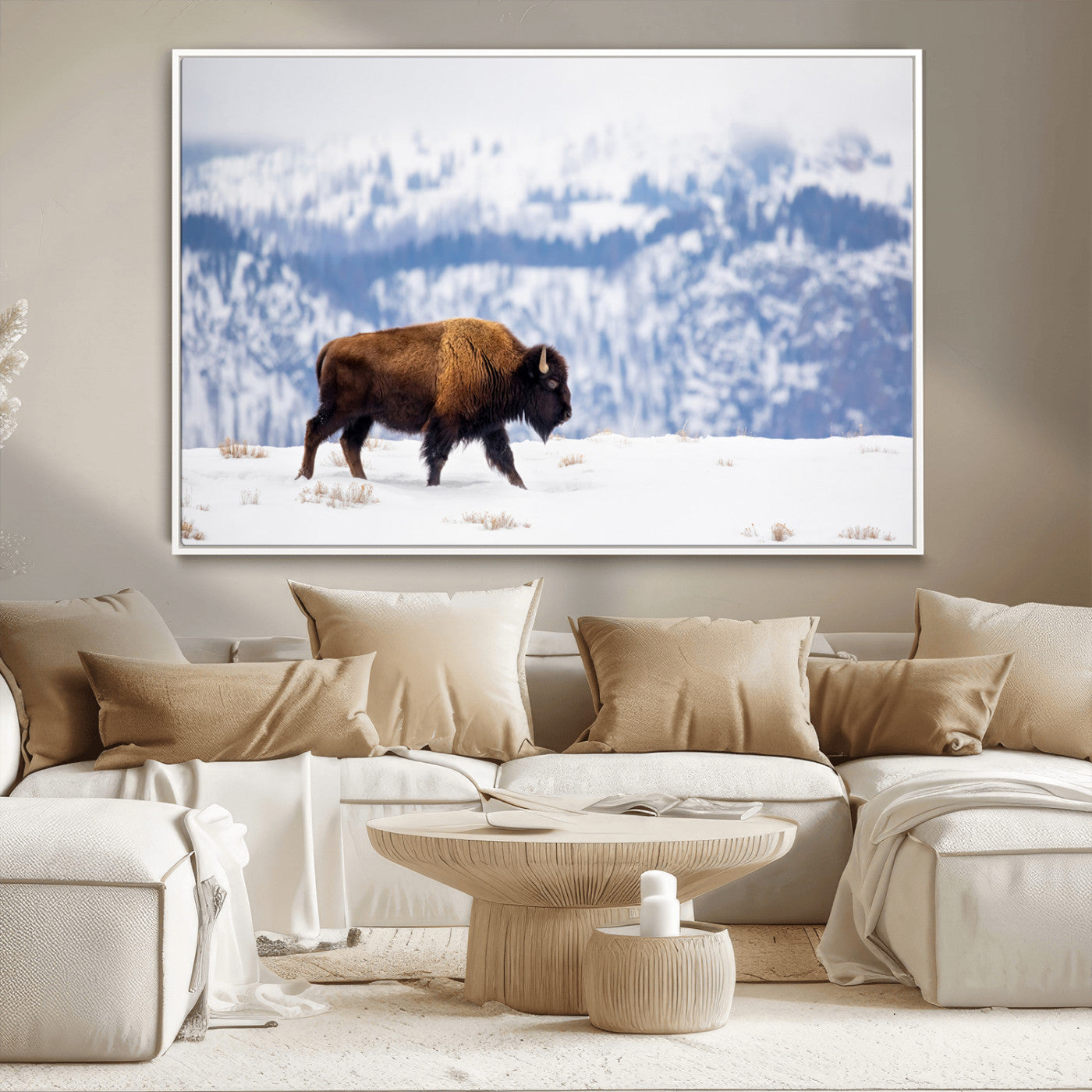 A lone bison walks across snowy ground with blue-toned mountain range behind, ideal for rustic or western farmhouse interiors.
