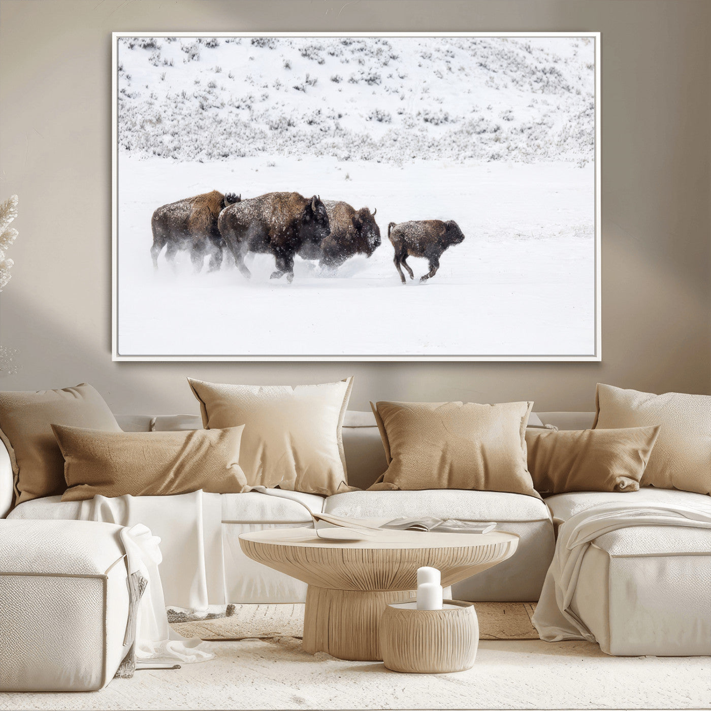 Bison herd running through a snowy open field with mountain backdrop, perfect for rustic or western-themed wall decoration.