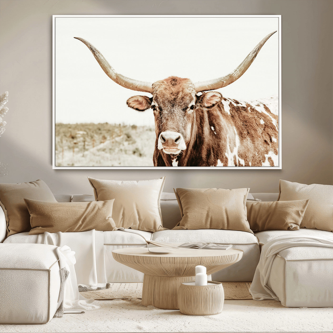 A Texas longhorn bull with wide horns, standing in a dry field under soft light, ideal for rustic farmhouse or western-themed interiors.