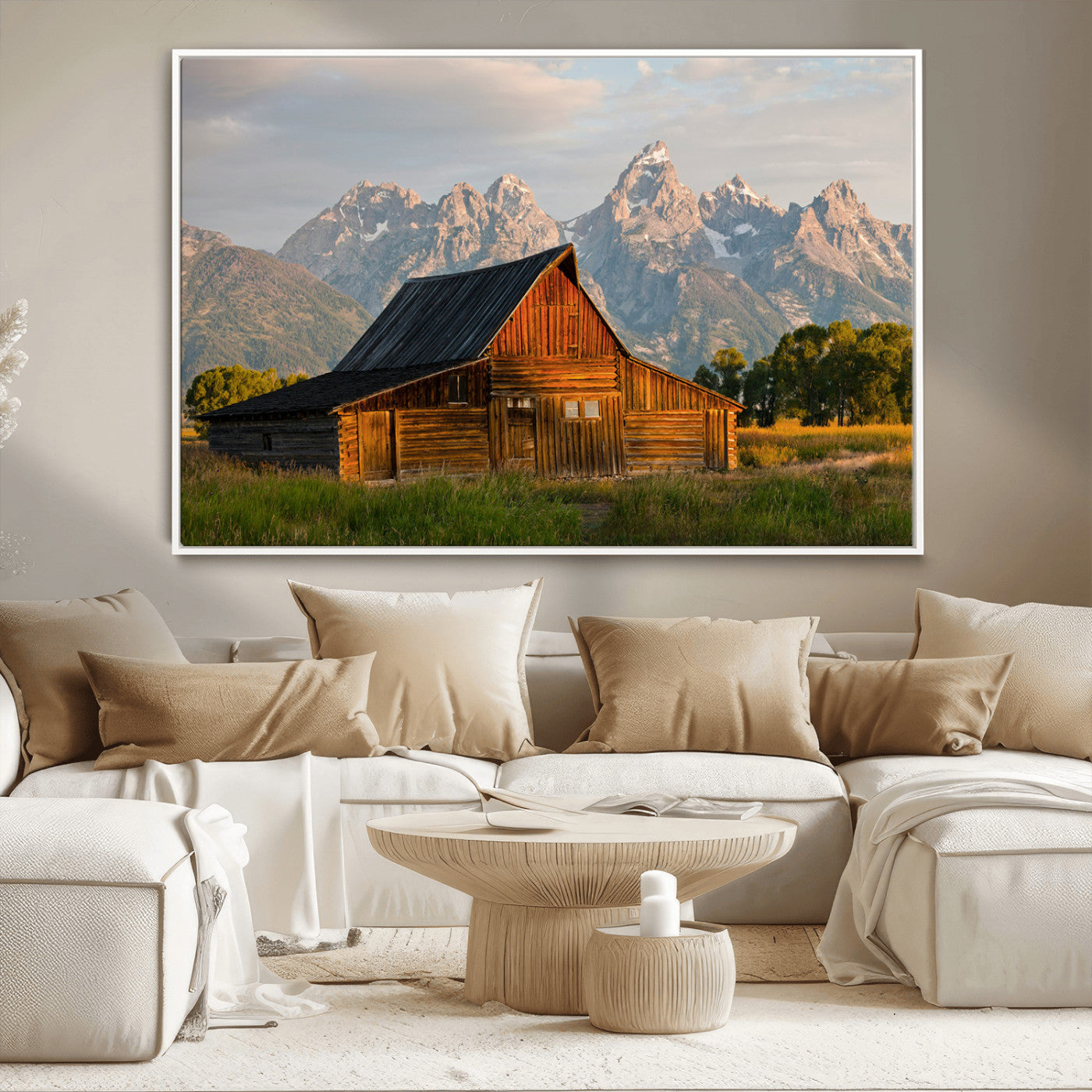 Rustic wooden barn set against towering mountain peaks under warm golden light, creating a peaceful Western countryside scene.