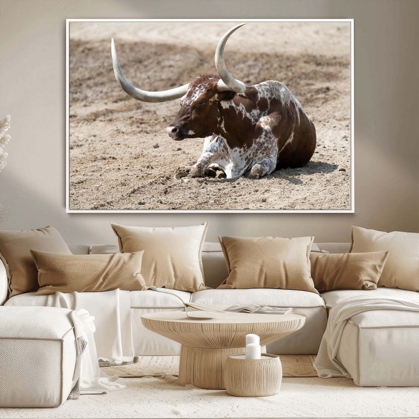 Texas Longhorn resting on sandy ground with large curved horns, capturing a rustic Western aesthetic perfect for farmhouse-style wall art.