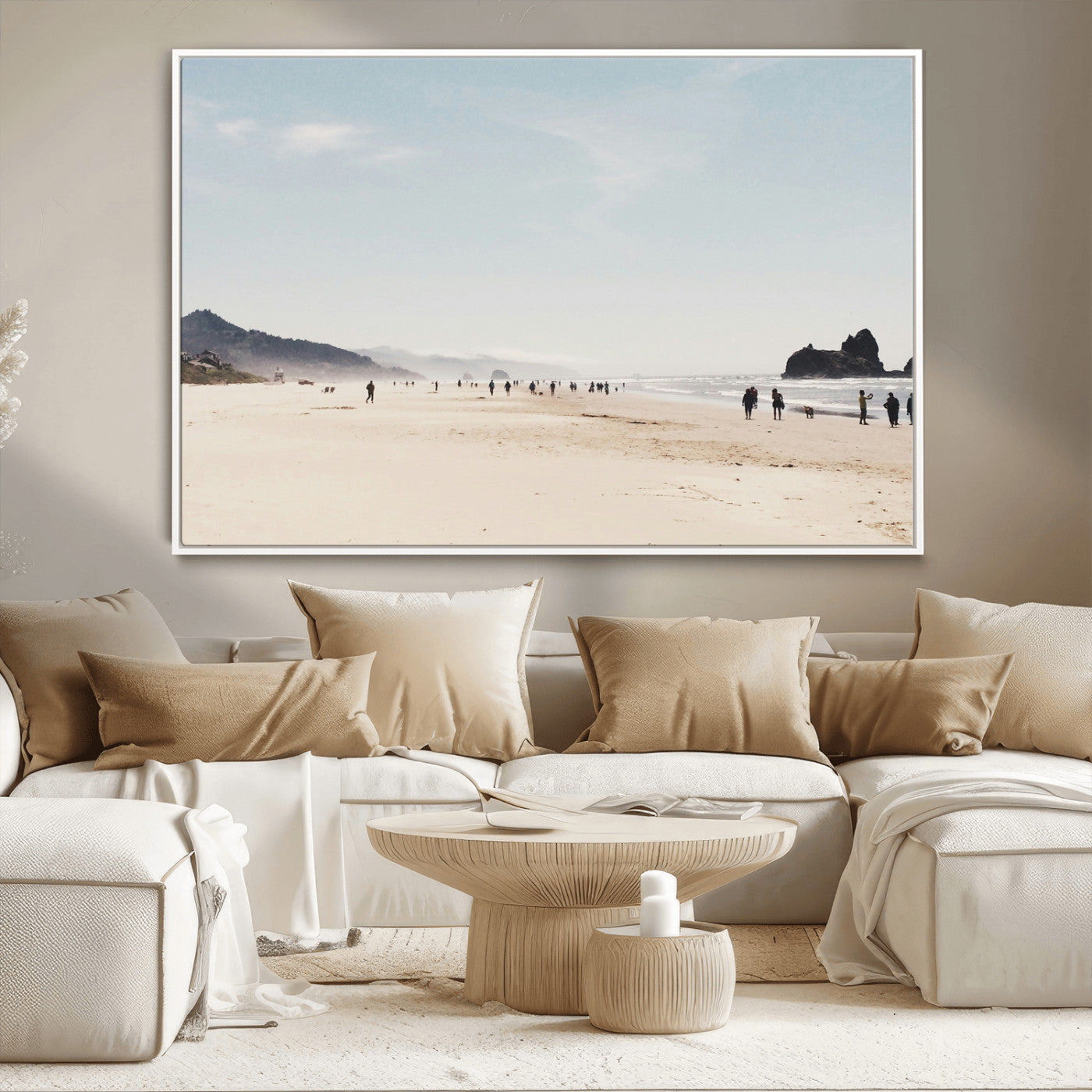 A serene beach with soft sand, misty mountains, and scattered people walking along the shoreline, creating a peaceful coastal landscape.