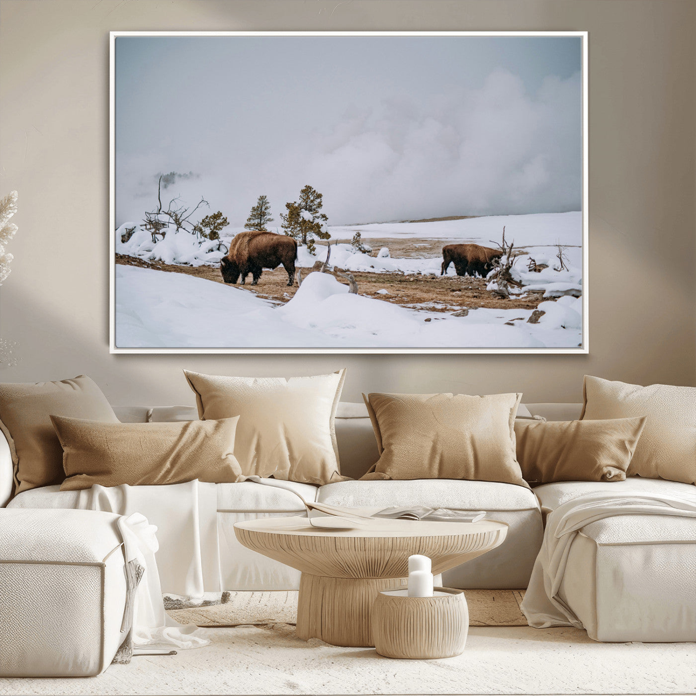 Two bison grazing in a snowy open landscape with misty hills in the background, creating a peaceful and rustic winter scene.