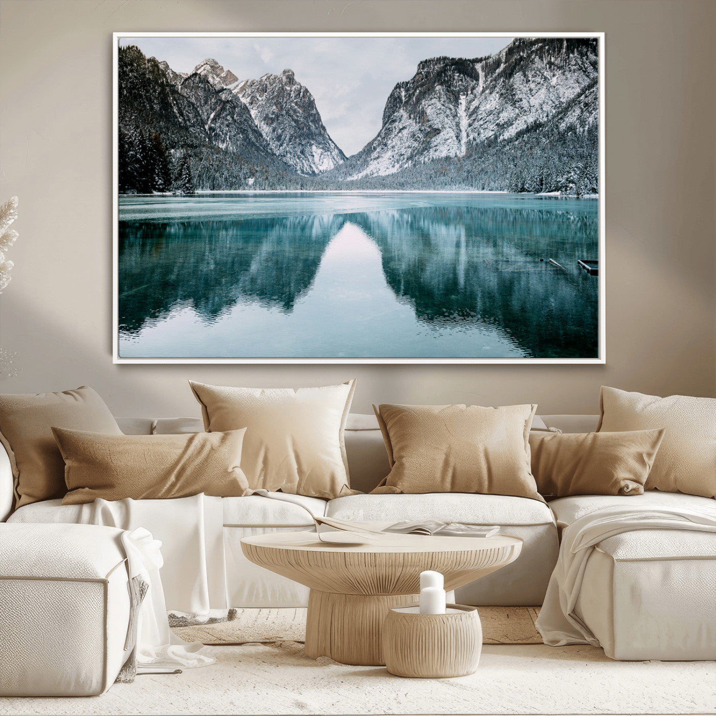 Crystal-clear alpine lake reflecting snow-covered mountains, surrounded by evergreen trees, creating a serene and tranquil winter landscape.