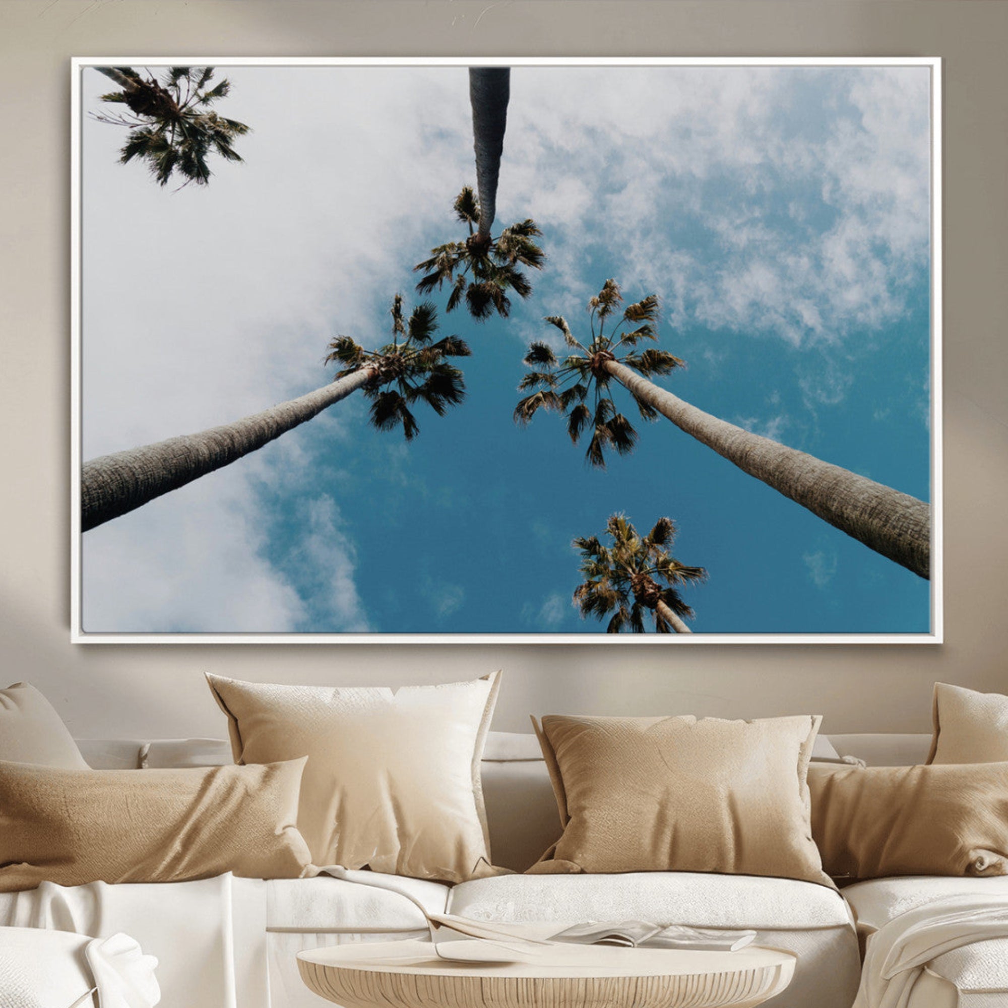 Looking up at tall palm trees against a bright blue sky with scattered clouds, creating a tropical and airy atmosphere for modern home decor.