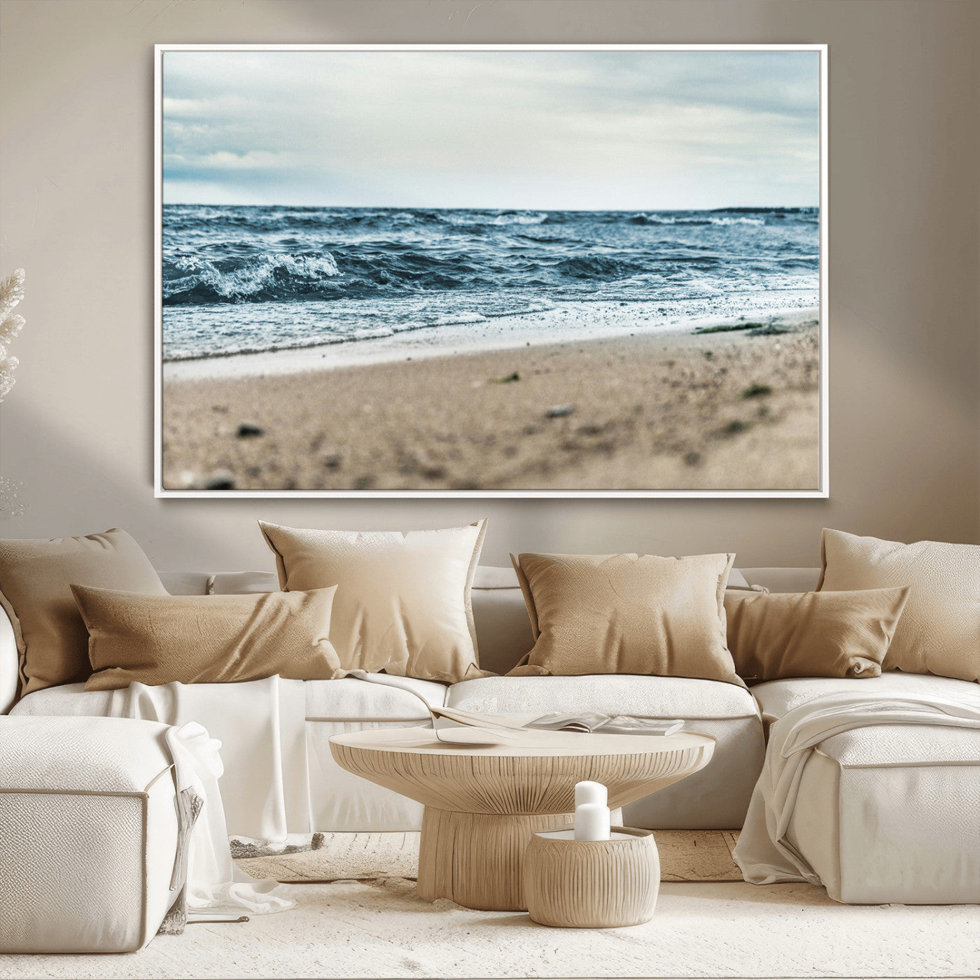 A moody ocean scene with gentle waves washing onto a sandy beach under a cloudy sky, creating a peaceful and coastal atmosphere.