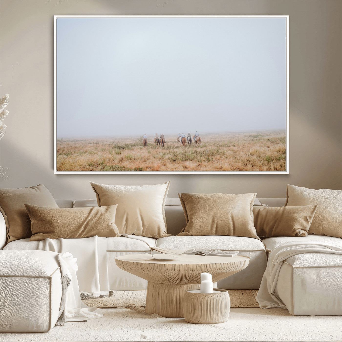 A group of horseback riders moving through a fog-shrouded field, evoking a calm Western scene with golden grasses and soft horizons.
