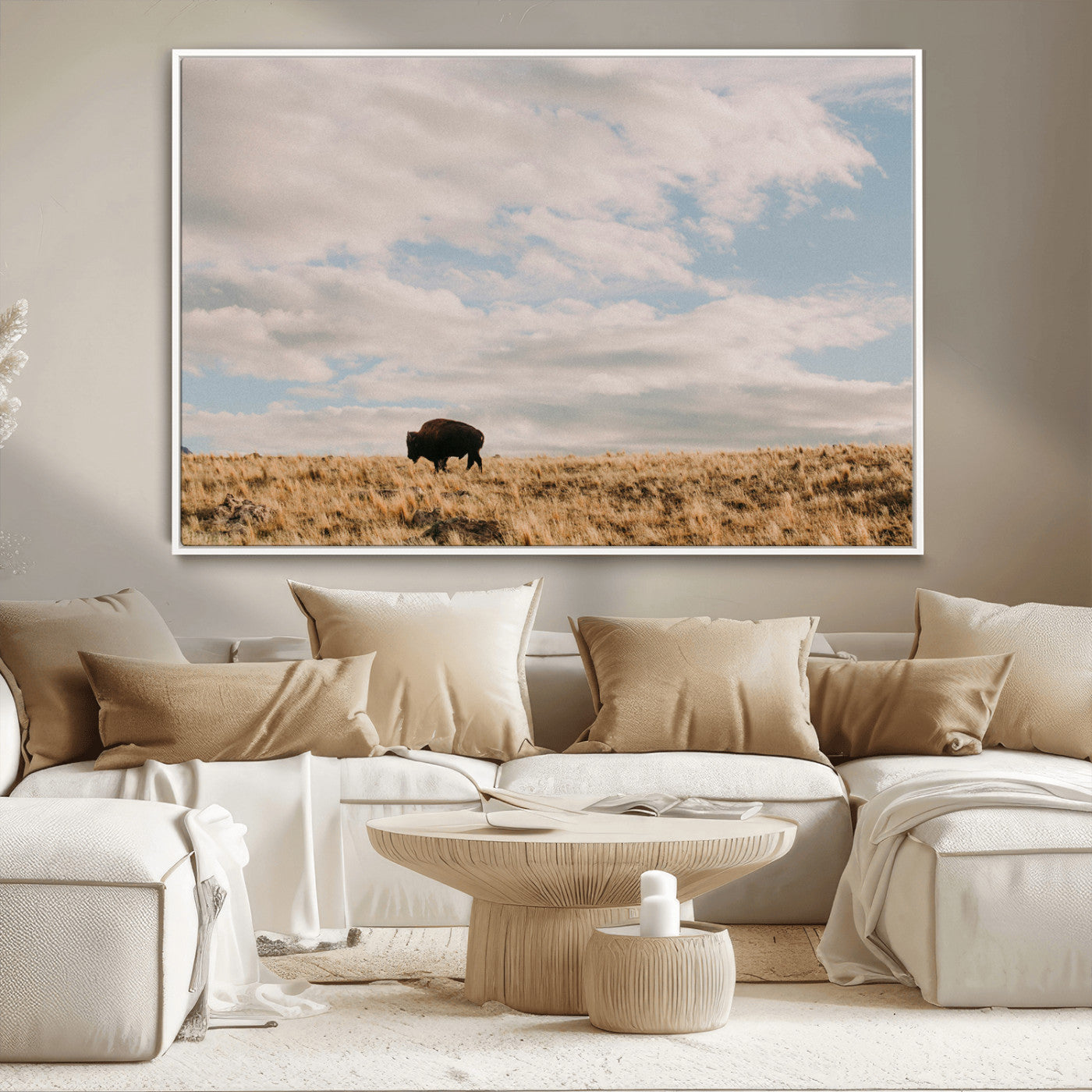 A solitary bison walking across a golden prairie under a vast, cloud-filled sky, evoking a peaceful, rustic western landscape for home decor.