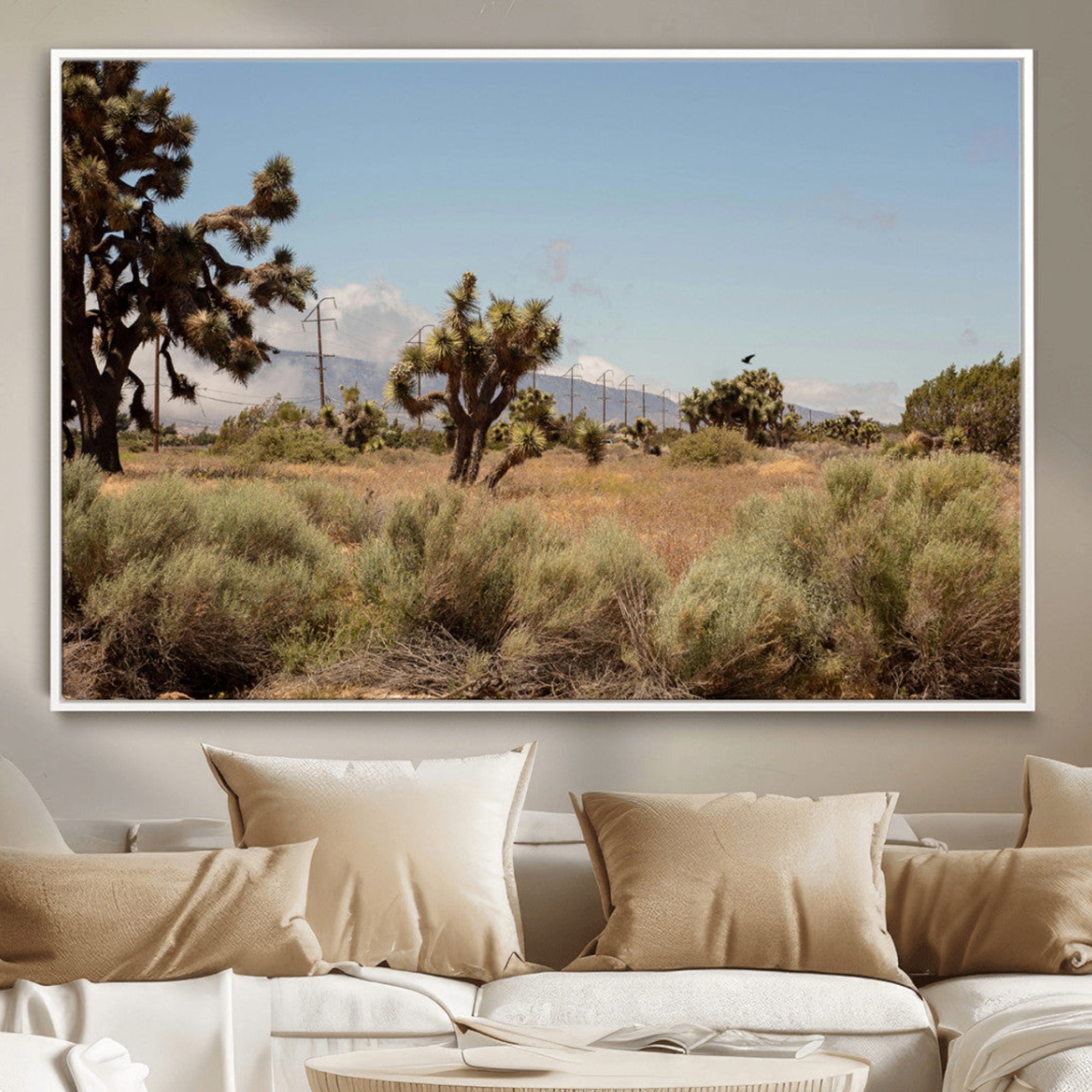 Scenic desert landscape with Joshua trees, dry grass, and distant mountains under a clear blue sky, perfect for southwestern and rustic decor.