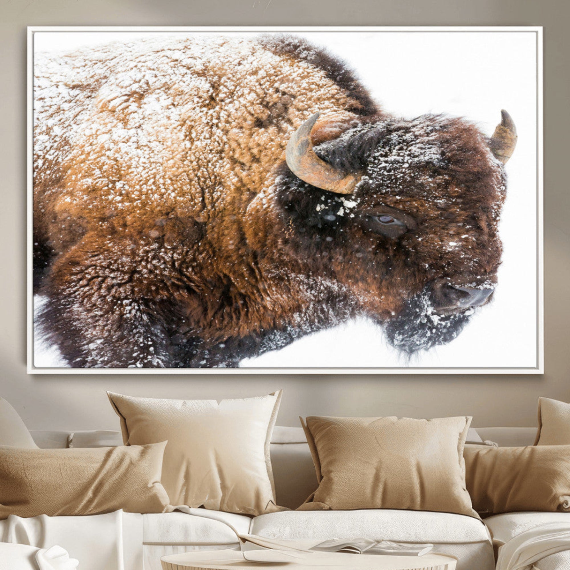 Close-up photograph of a bison covered in snow, highlighting its thick fur and powerful presence, set against a white winter backdrop, ideal for rustic decor.