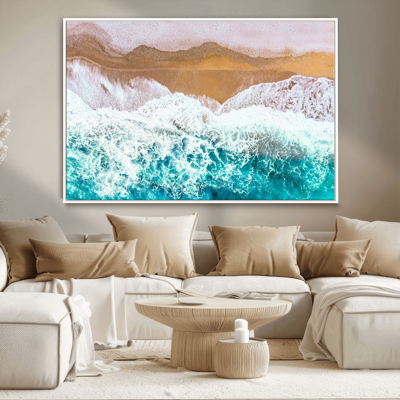 Aerial view of ocean waves crashing onto a sandy beach, with turquoise water and foamy white surf, creating a serene coastal aesthetic for home decor.