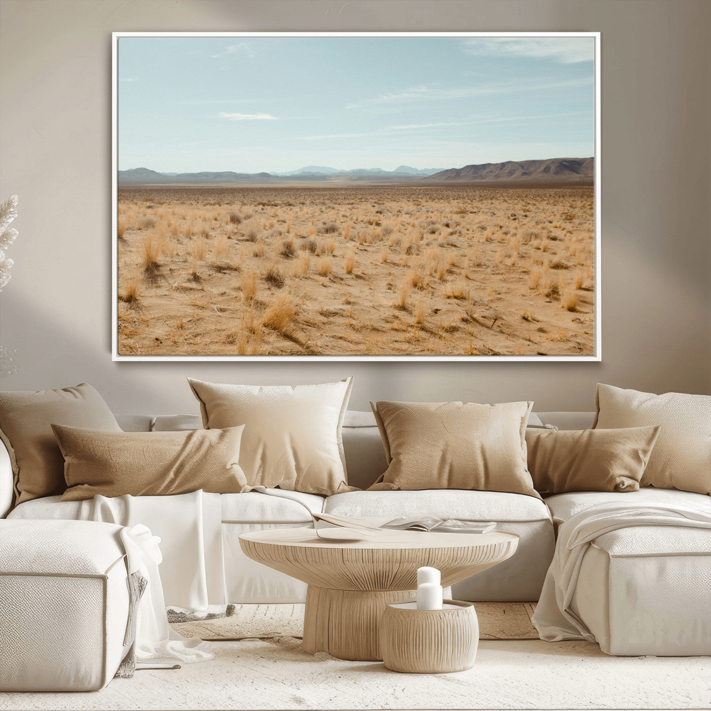 Expansive desert landscape with scattered dry grass and distant mountain range under a pale blue sky – Wall Art Canvas Print.