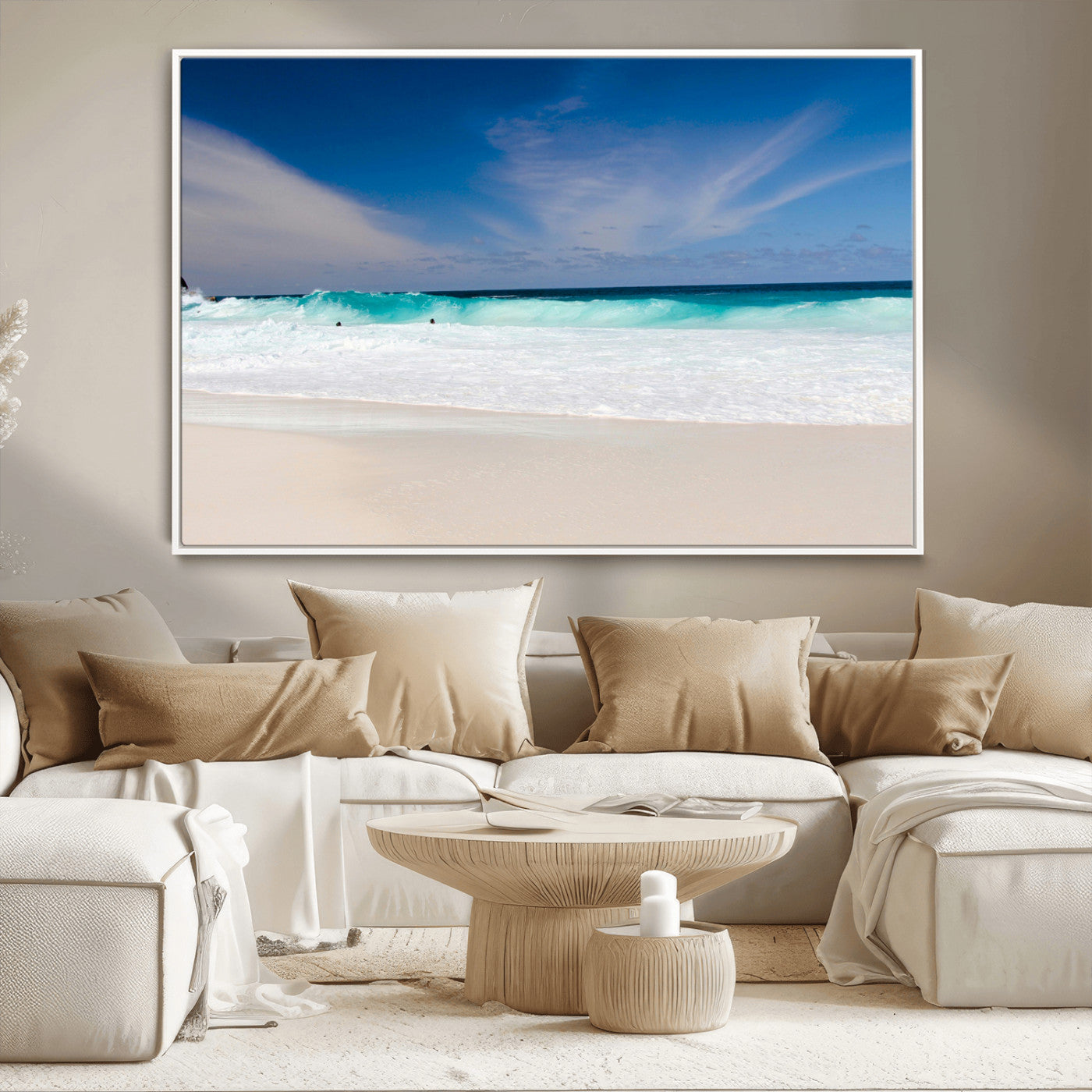 Turquoise waves crash onto a pristine white sand beach under a vivid blue sky with wispy clouds, creating a peaceful and refreshing coastal scene.