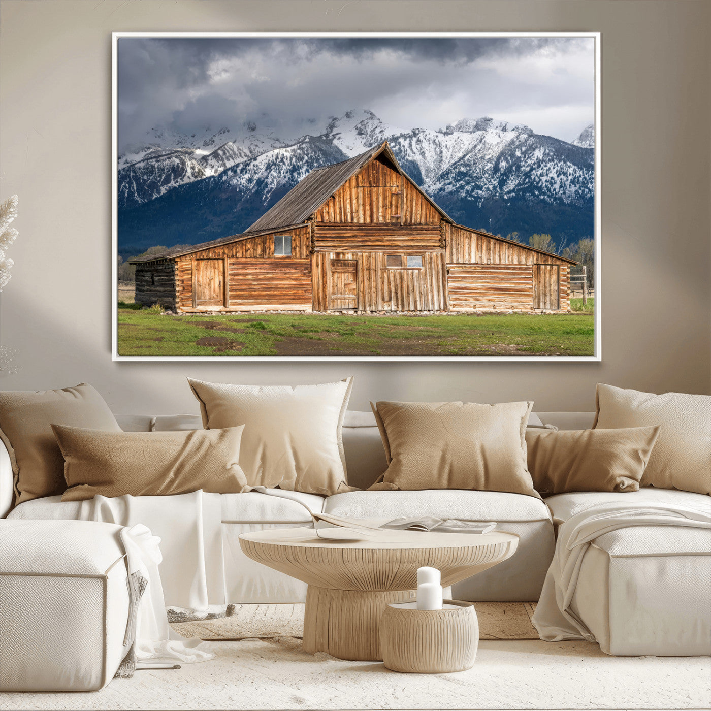 A stunning wall art canvas print featuring a rustic wooden barn set against a backdrop of snow-capped mountains under a dramatic cloudy sky, perfect for adding a touch of rural charm to any space.