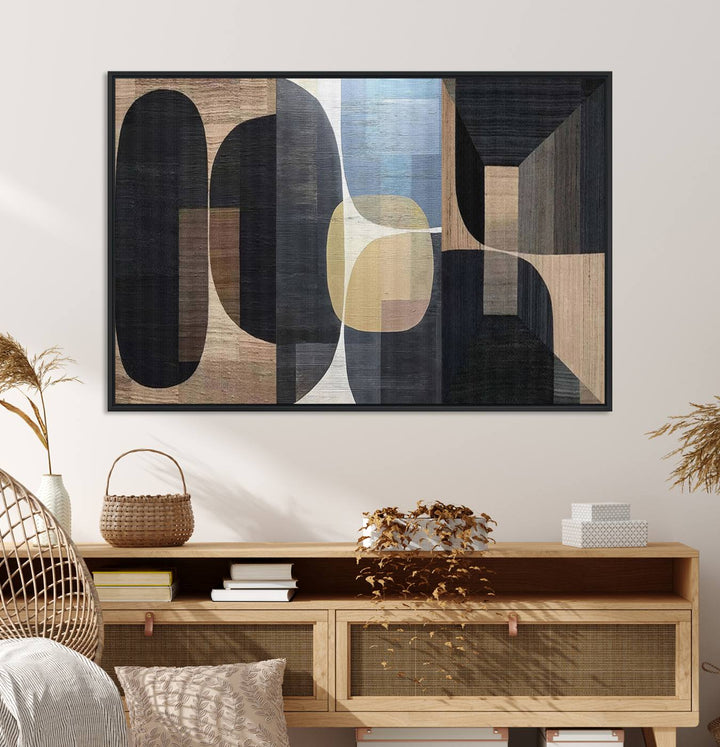 Abstract geometric wall art featuring black, gray, beige, and blue tones framed in a wooden border.