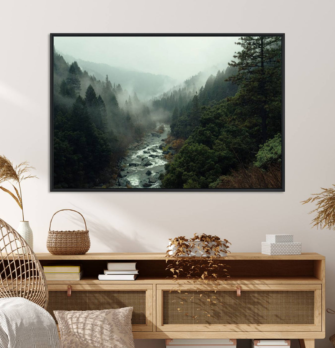 The Misty Forest Wall Art features a serene landscape with a misty river and evergreens, ideal for enhancing the ambiance of any living room or cabin.