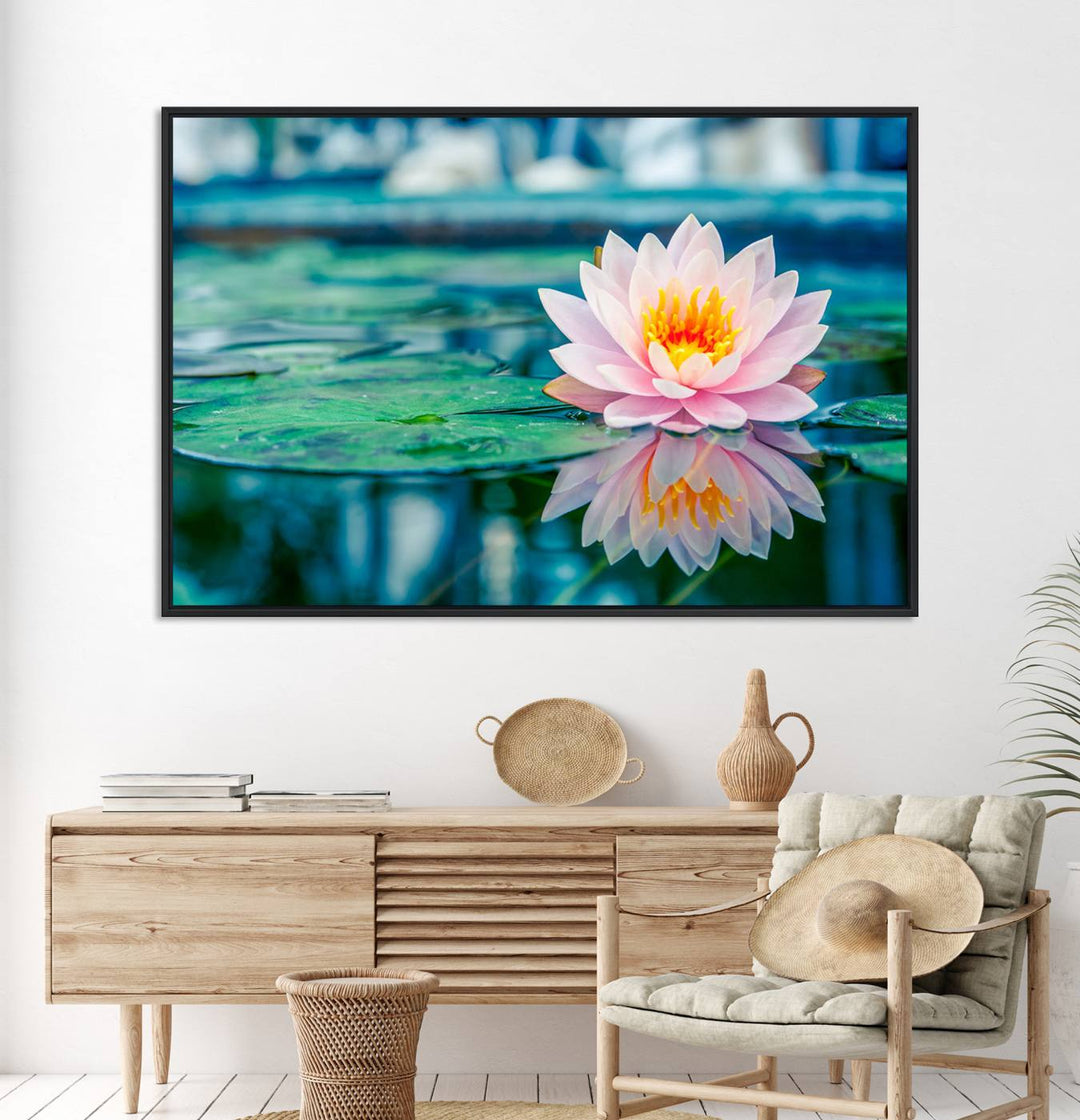 The Lotus Flower Canvas Print showcases a pink water lily with a yellow center gracefully floating on a calm pond.