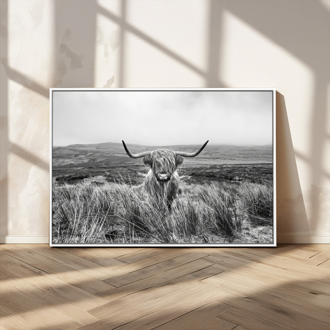 A black and white portrait of a Highland cow in a foggy Scottish countryside, capturing a rustic aesthetic and tranquil farm escape.