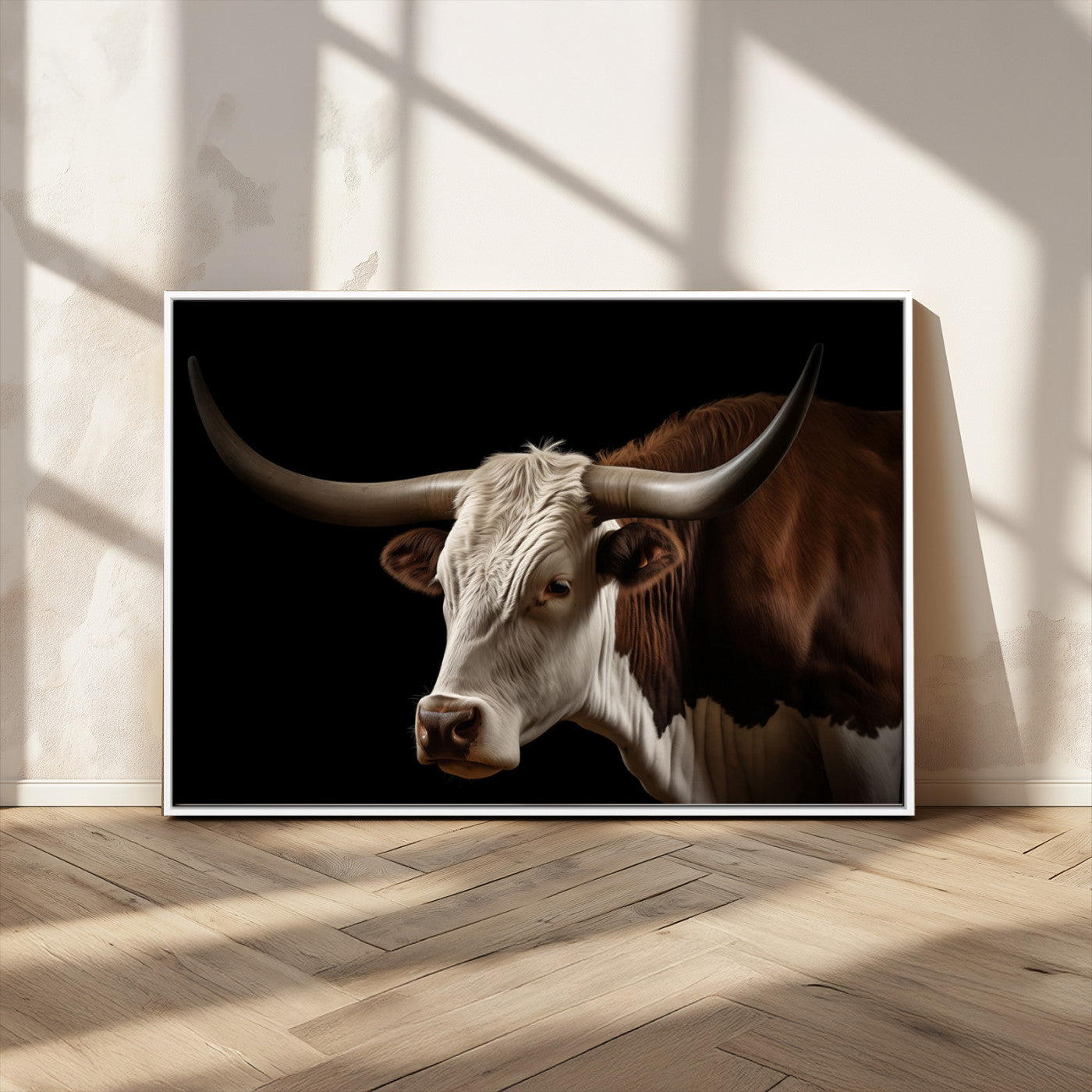 "Close-up of a brown and white longhorn cow with prominent curved horns against a black background."