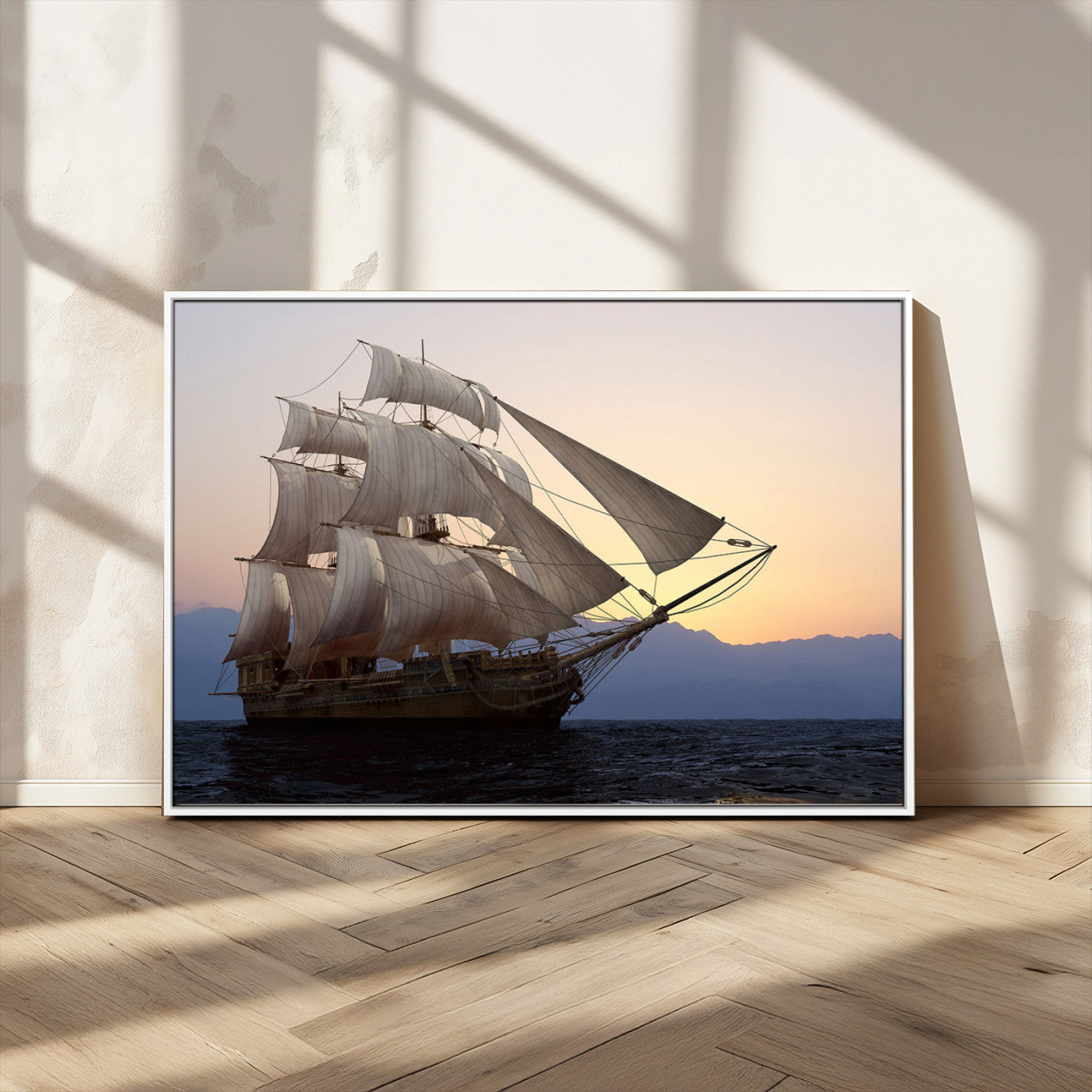 Majestic tall ship with full sails gliding across the ocean at sunset, with mountain silhouettes in the background – Wall Art Canvas Print.