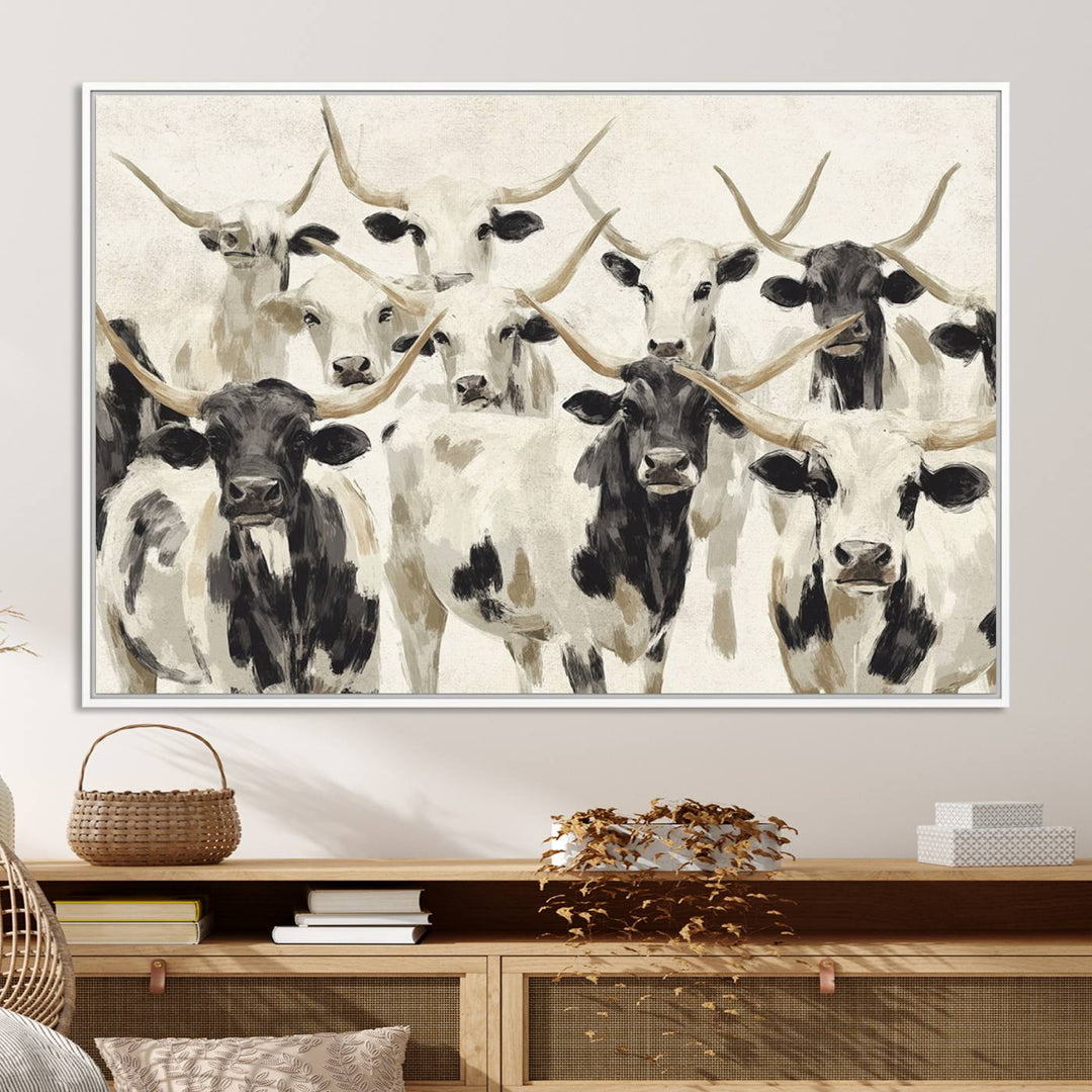 Canvas print titled Longhorn Texas Cow Drawing, depicting longhorn cattle with black and white markings, made in the USA, displayed on the wall.