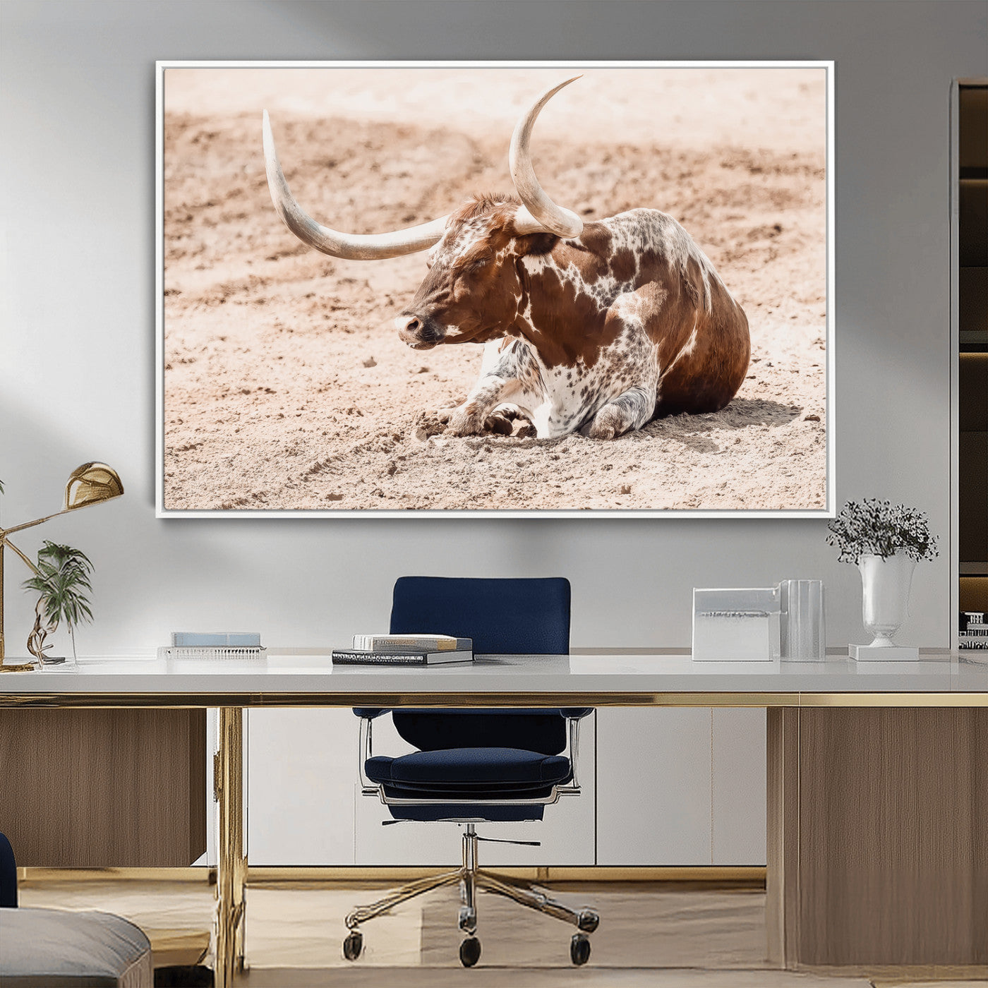 Texas Longhorn bull resting on dusty ground with warm tones, ideal for rustic western or farmhouse-themed wall decor.