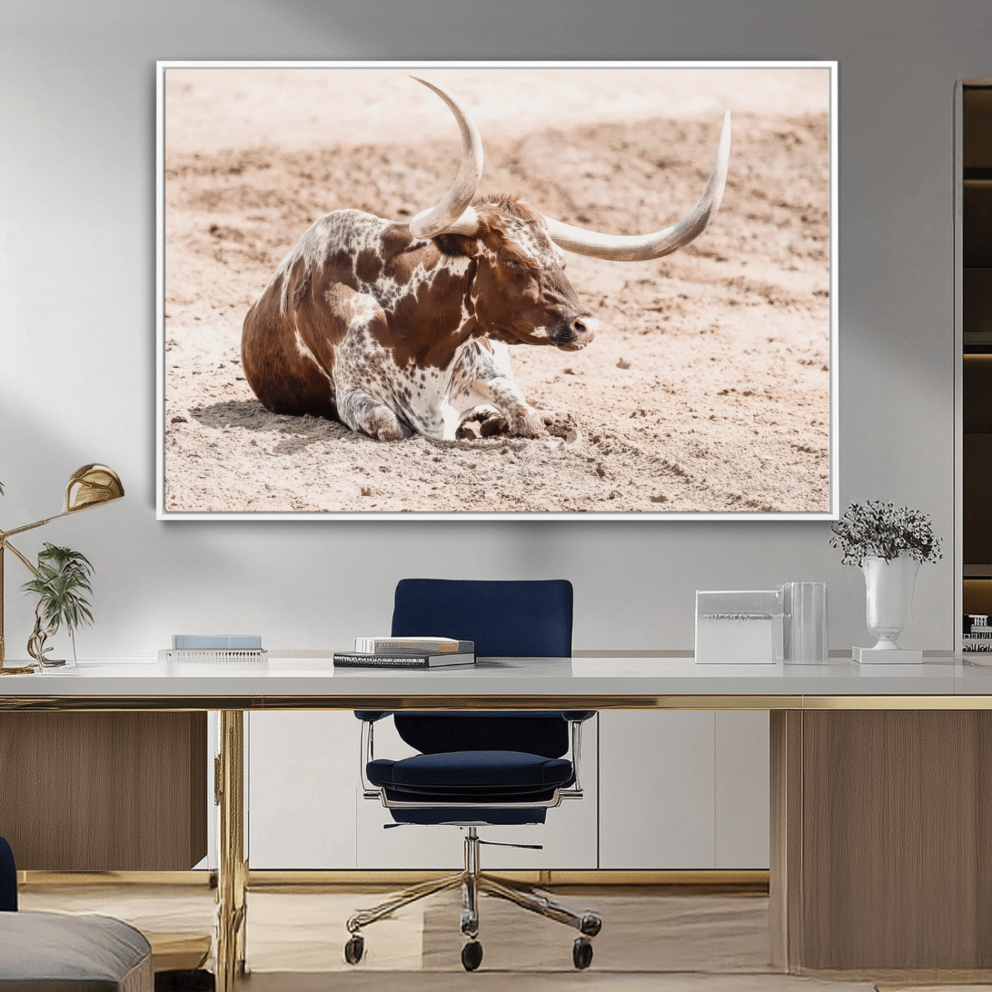 Texas Longhorn bull resting on dusty ground with warm tones, ideal for rustic western or farmhouse-themed wall decor.