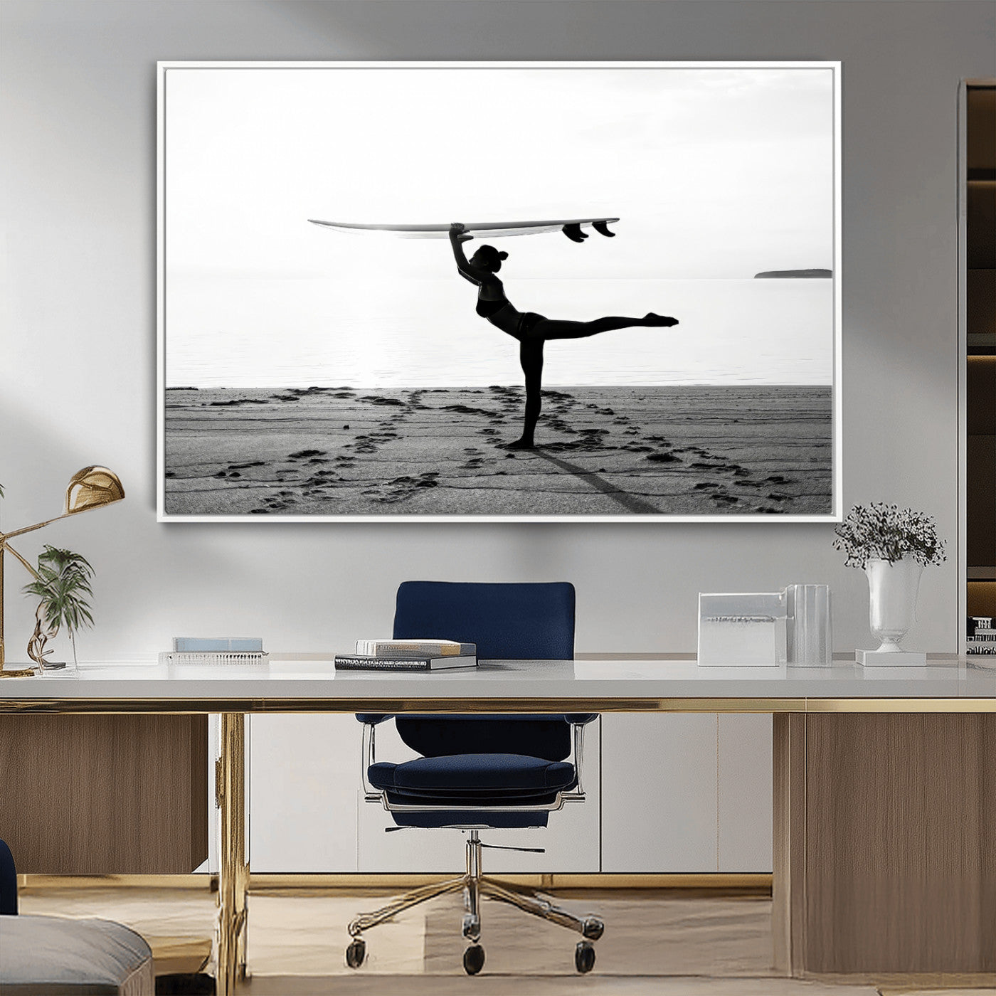 A woman balances a surfboard on her head while striking a yoga pose on the beach, silhouetted against a calm ocean horizon.