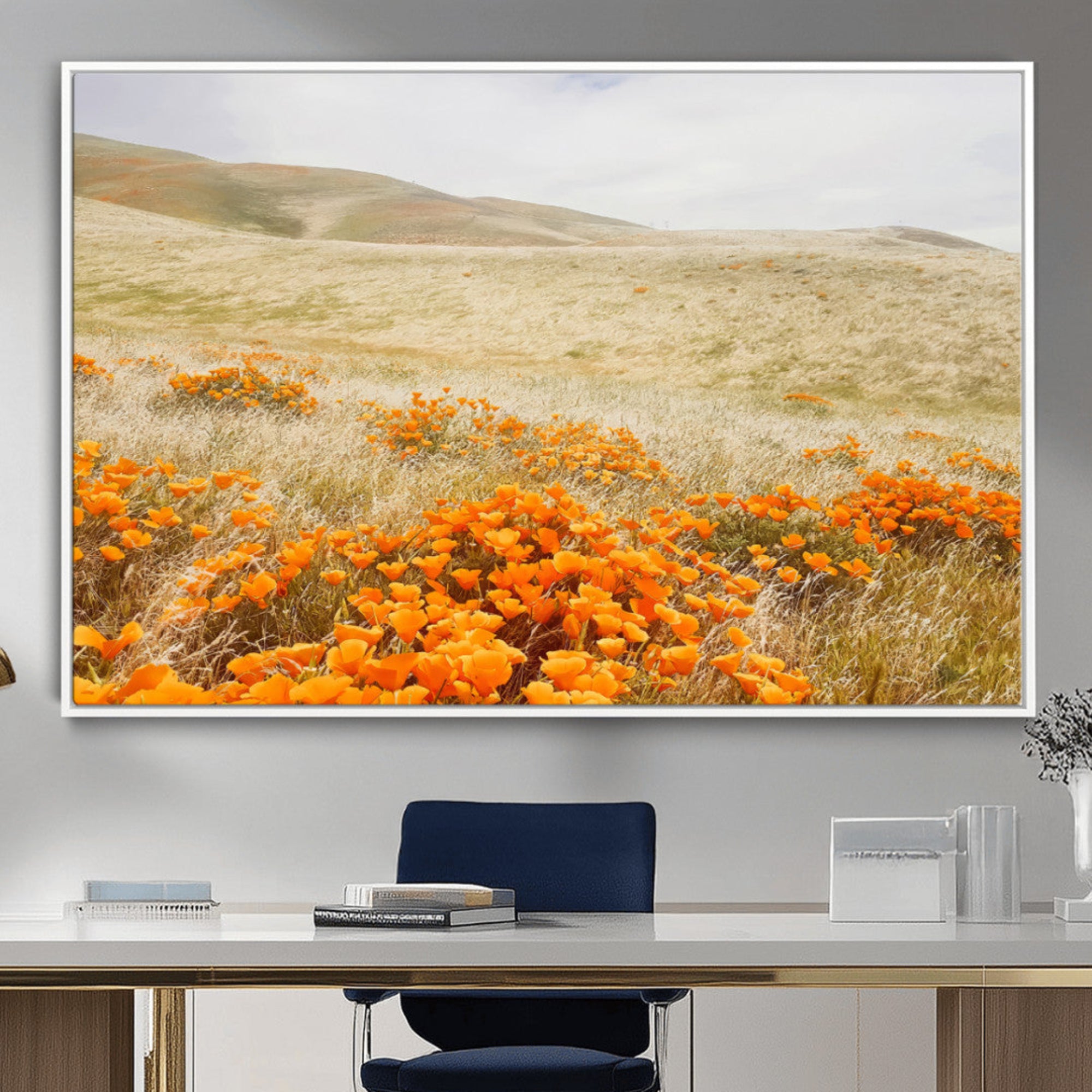 A golden field with vibrant orange poppies blooming across rolling hills under a soft, sunlit sky, creating a warm and rustic landscape.