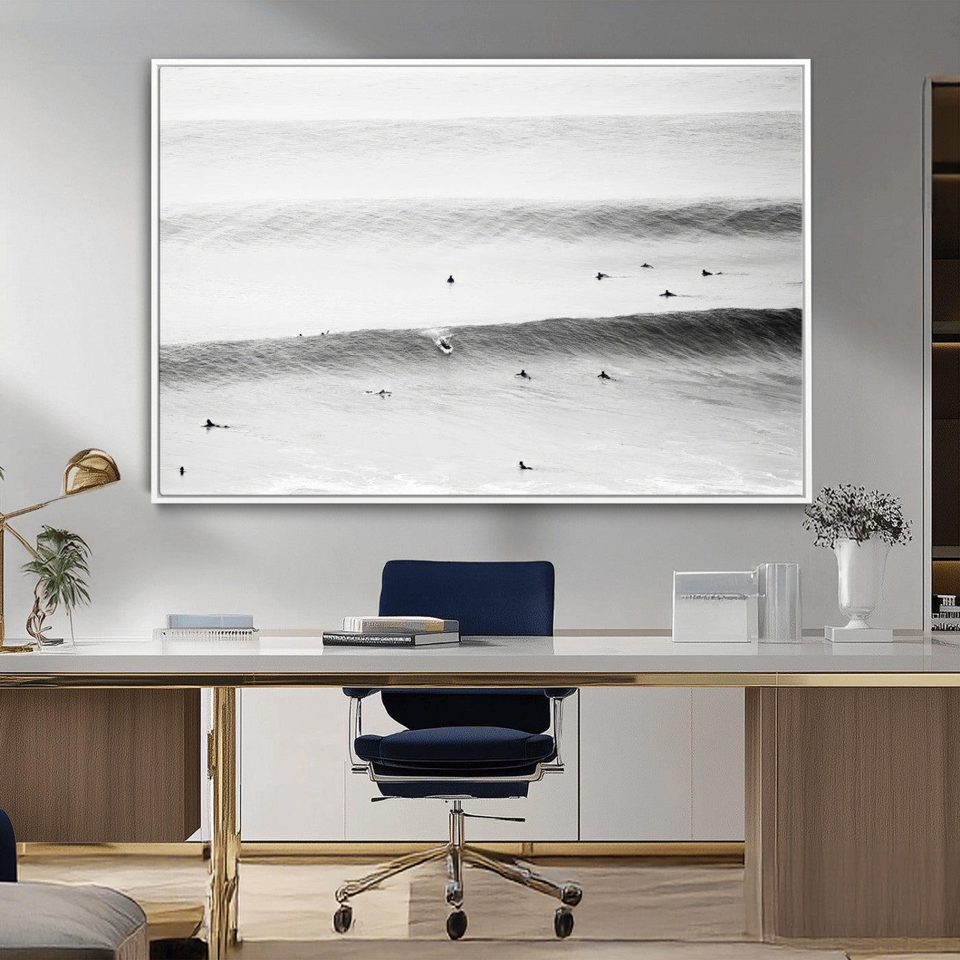 A monochrome photograph of swimmers gliding through gentle ocean waves, evoking a sense of calm and movement.