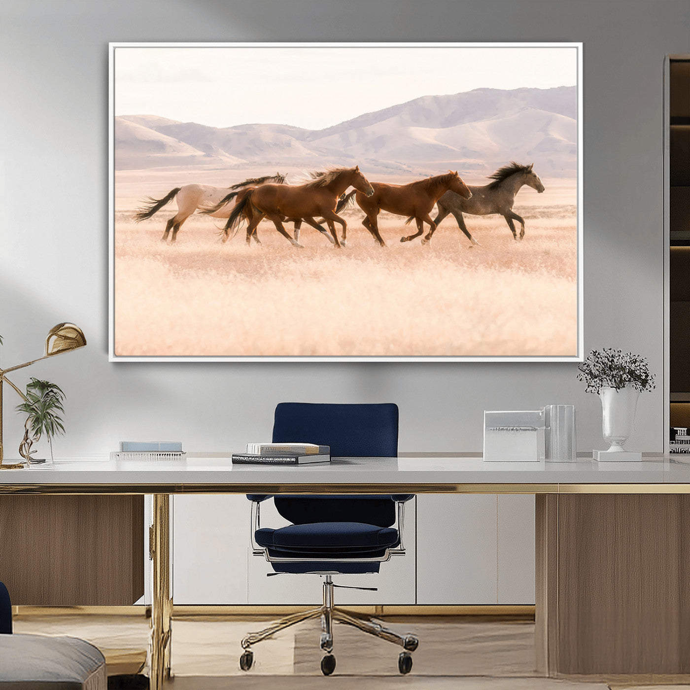A herd of wild horses galloping through a sunlit desert plain with mountains in the background, perfect for rustic or western-themed wall decor.